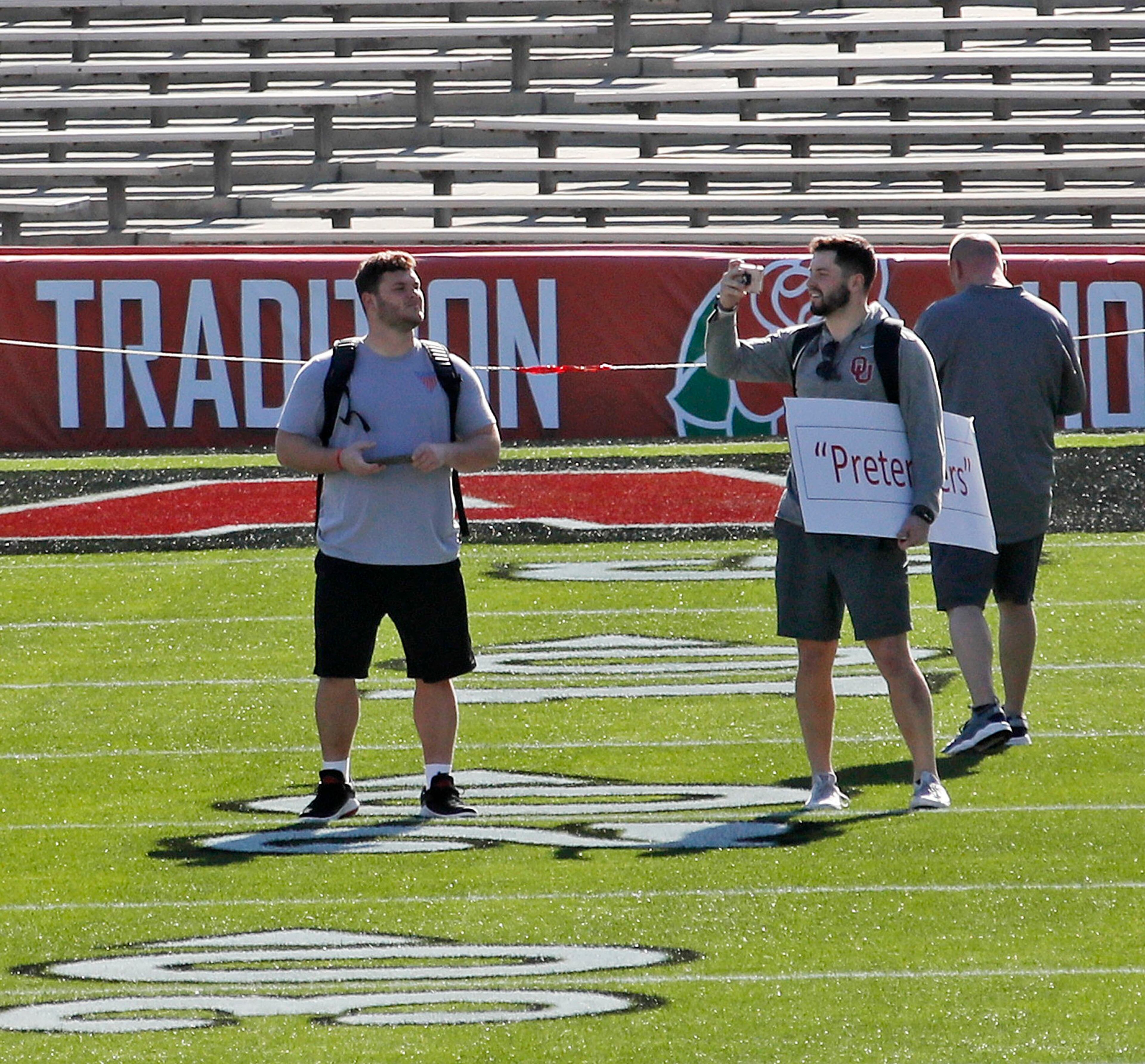 12/31/17 - Los Angeles - Oklahoma players, including quarterback Baker Mayfield (holding "Pretenders" sign) visited the field after taking a team photo. Both Georgia and Oklahoma made appearances at the stadium to take team photos. Georgia plays Oklahoma in a NCAA football playoff game on Monday at Spieker Field, and a victory there, will put the Bulldogs in Mercedes-Benz Stadium on Jan. 8 to play one of two rivals -- Alabama or Clemson -- for the national title. AJC Photo