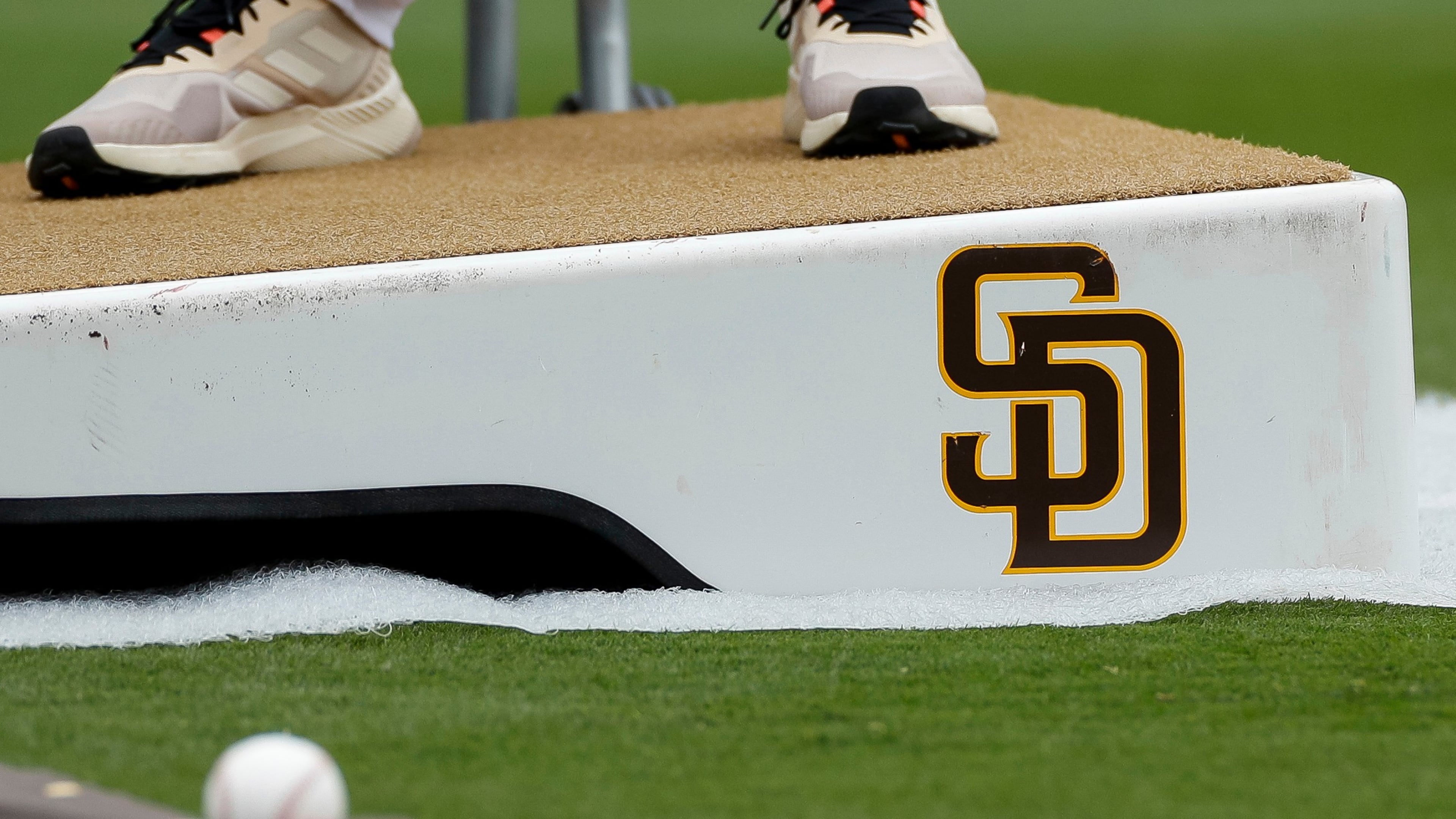 FILE - Detailed view of a San Diego Padres logo on a pitching mound during batting practice prior to a baseball game between the Padres and Boston Red Sox, May 20, 2023, in San Diego. (AP Photo/Brandon Sloter, File)