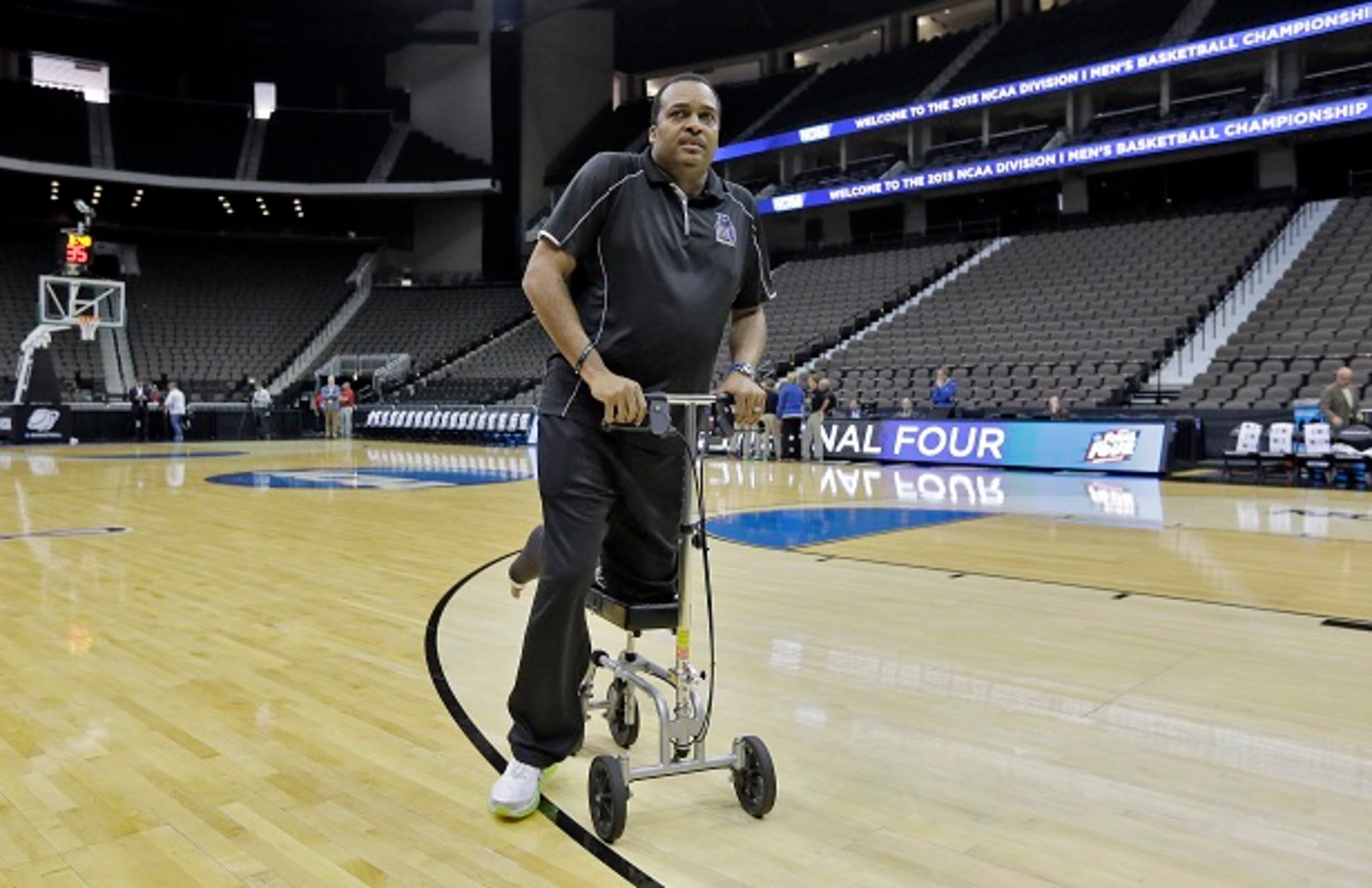 Georgia State head coach Ron Hunter wheels himself off the court after practice at the NCAA college basketball tournament, Wednesday, March 18, 2015, in Jacksonville, Fla. Georgia State plays Baylor in the second round on Thursday. Hunter is recovering from a torn Achilles tendon. (AP Photo/Chris O'Meara) Ron Hunter, wheeling away. (Chris O'Meara/AP photo)