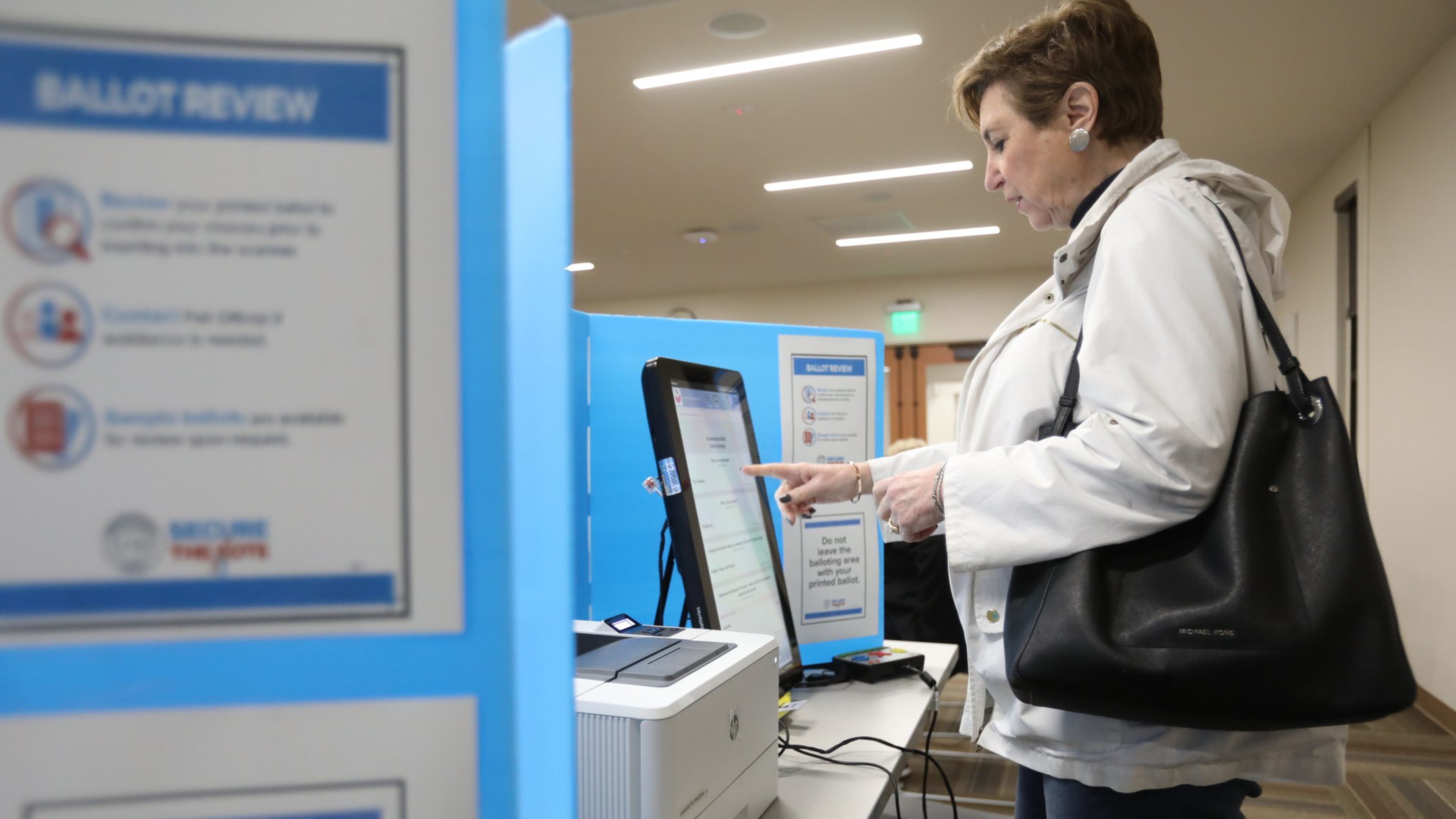 Andrea Settles, from Sandy Springs practices completing a ballot on one of Fulton County’s new voting machines during a mock election held at Sandy Springs Library on Tuesday, Feb. 18, 2020. She mentioned that the voting process was easy, but for Election Day, they will need to have a lot of signs instructing the voters on the new process.
