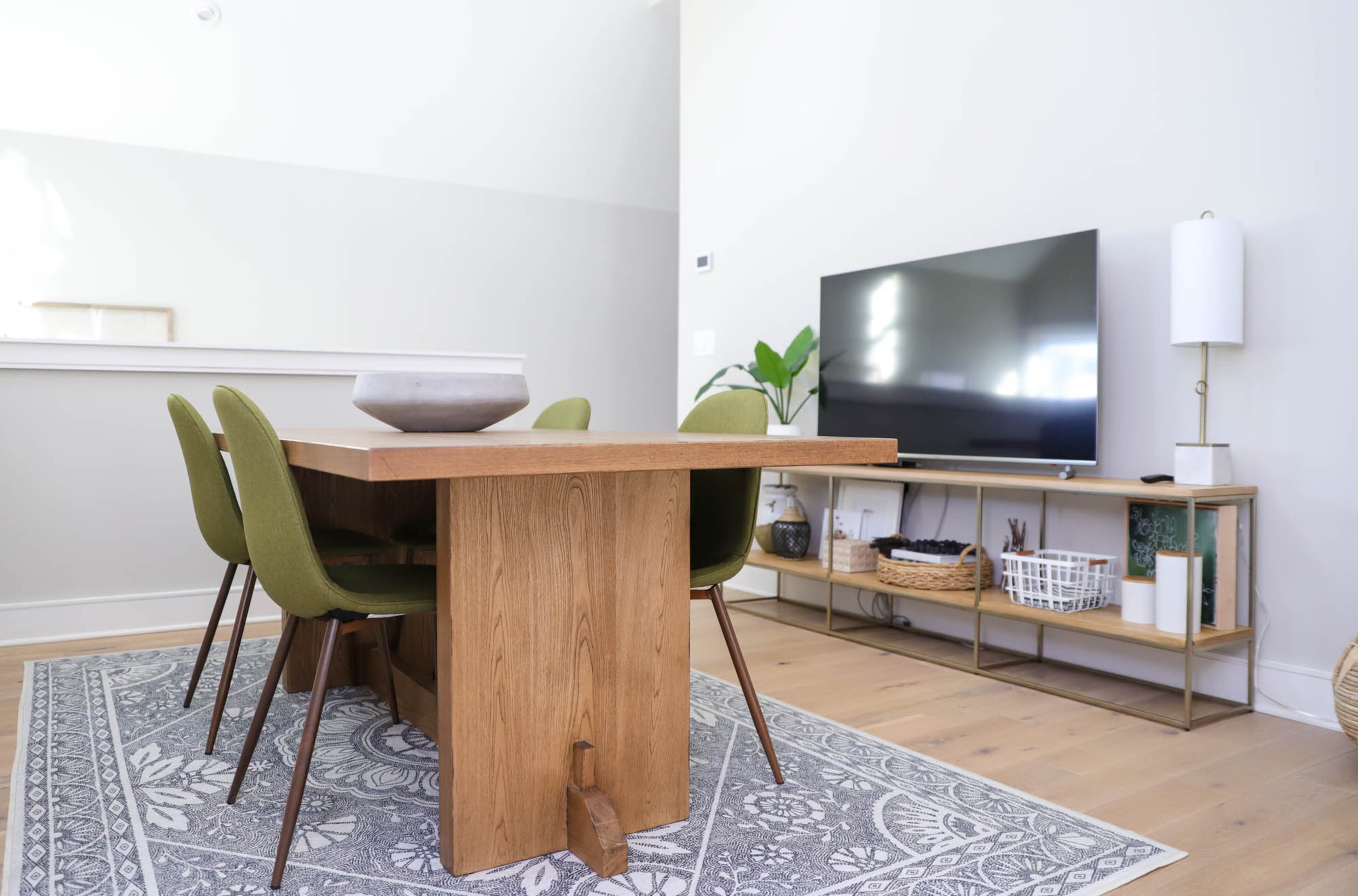 Bethany Jones started her design firm, Bethany Jones Interiors, just over a year ago. In the course of the last year, when she decided that she needed to expand her team, she decided to create a studio workspace for her team to gather, brainstorm and spread out materials to form their designs. A table from Leyland Blue and green accent chairs from Target give the firm room to work and meet, and a patterned area rug from Ruggable grounds the space. Text by Shannon Dominy/Photo by Reynolds Rogers