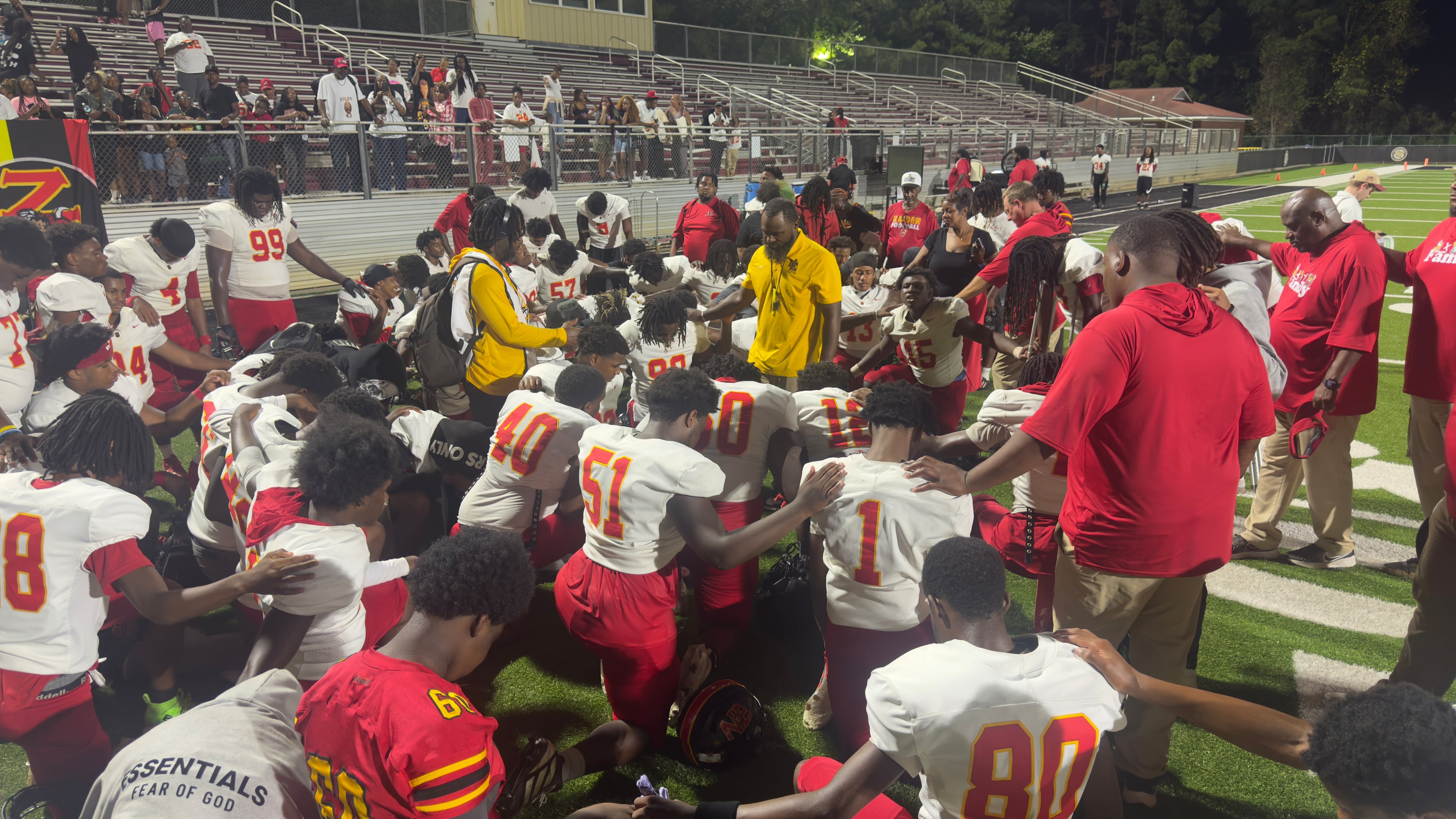 Northeast High School coach Jeremy Wiggins leads his team in prayer after its 59-19 win over Rutland High School on Thursday, Oct. 1, 2026, at the Ed DeFore Sports Complex in Macon. (Joe Kovac Jr. / AJC)
