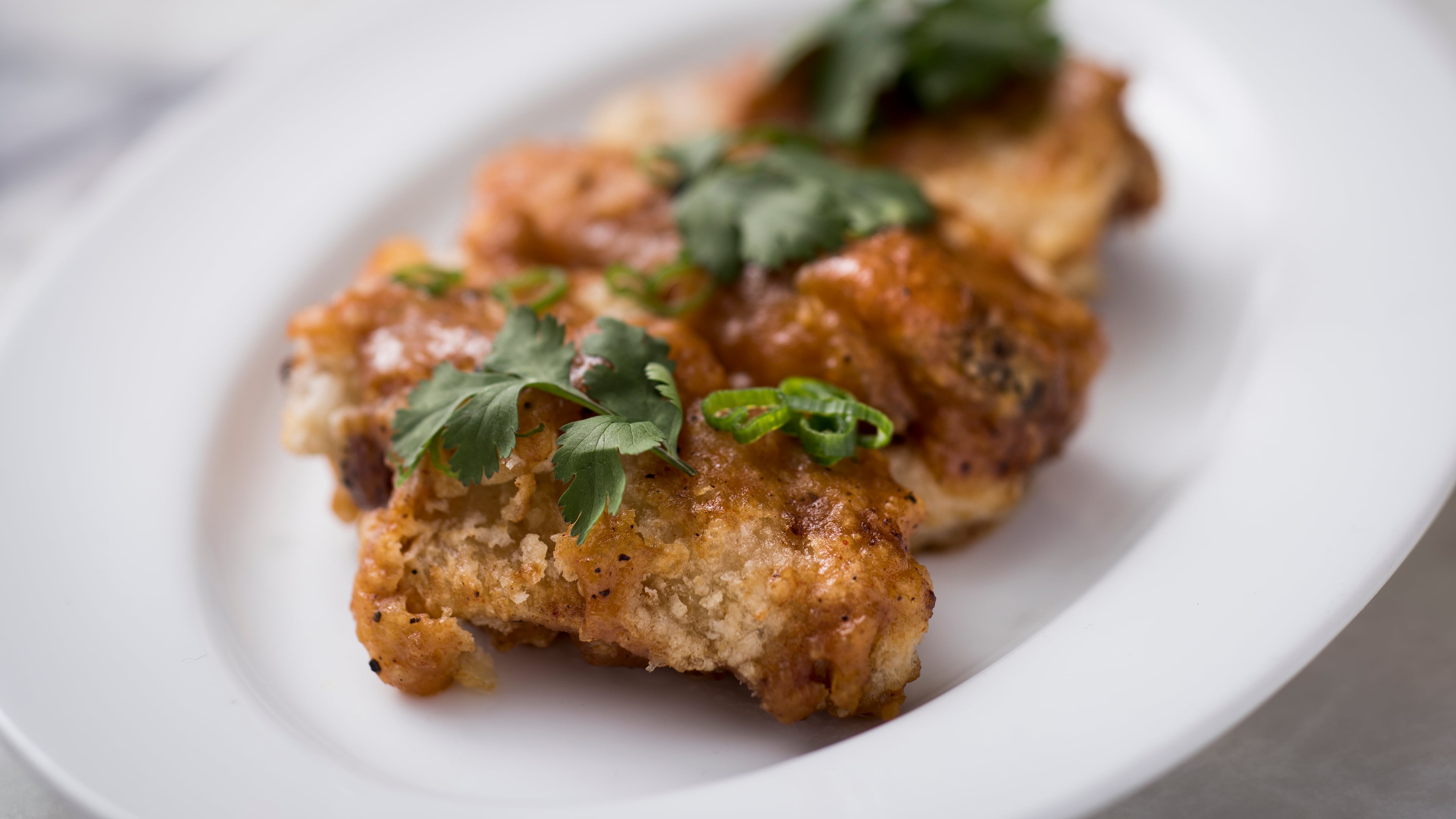 Spicy Chinese mustard chicken wings at Fung Tu, in New York, Jan. 26, 2016. A few dozen influential Chinese-American chefs seem determined to begin a new culinary conversation with the food of their ancestors, striving to invent a kind of Chinese-American food that is modern, creative and delicious instead of sweet, sticky and bland.