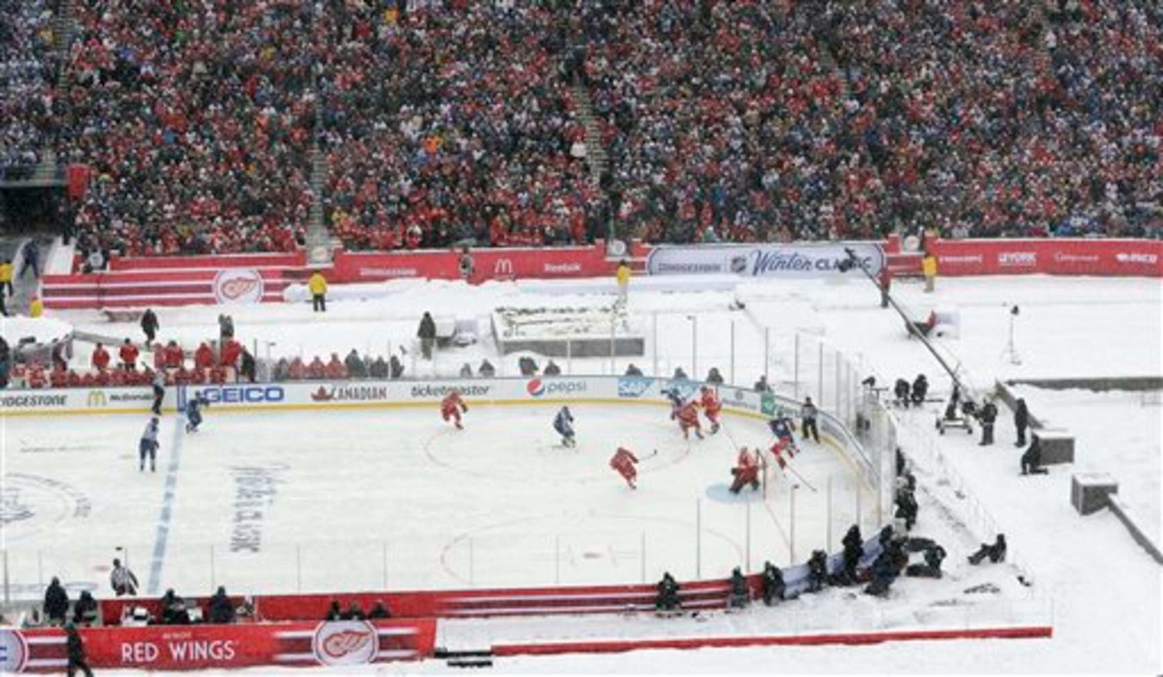 The Toronto Maple Leafs and the Detroit Red Wings play during the first period of the Winter Classic outdoor NHL hockey game at Michigan Stadium in Ann Arbor, Mich., Wednesday, Jan. 1, 2014. (AP Photo/Carlos Osorio)