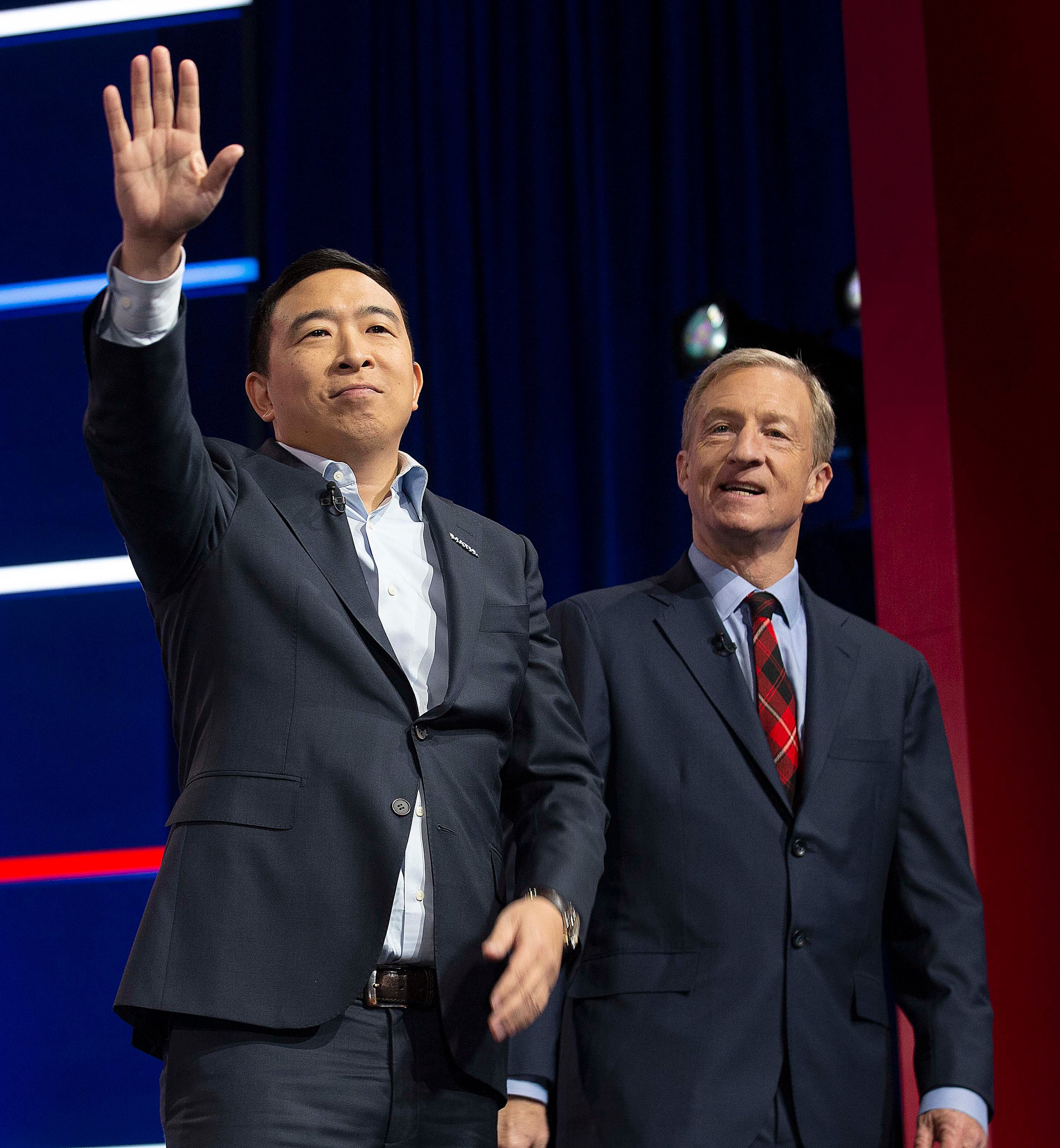 11/20/2019 -- Atlanta, Georgia -- Businessmen and democratic candidates Andrew Yang (left) and Tom Steyer (right) take the stage, during the MSNBC/The Washington Post Democratic Presidential debate inside the Oprah Winfrey Soundstage at Tyler Perry Studios, Monday, November 20, 2019. (Alyssa Pointer/Atlanta Journal Constitution)