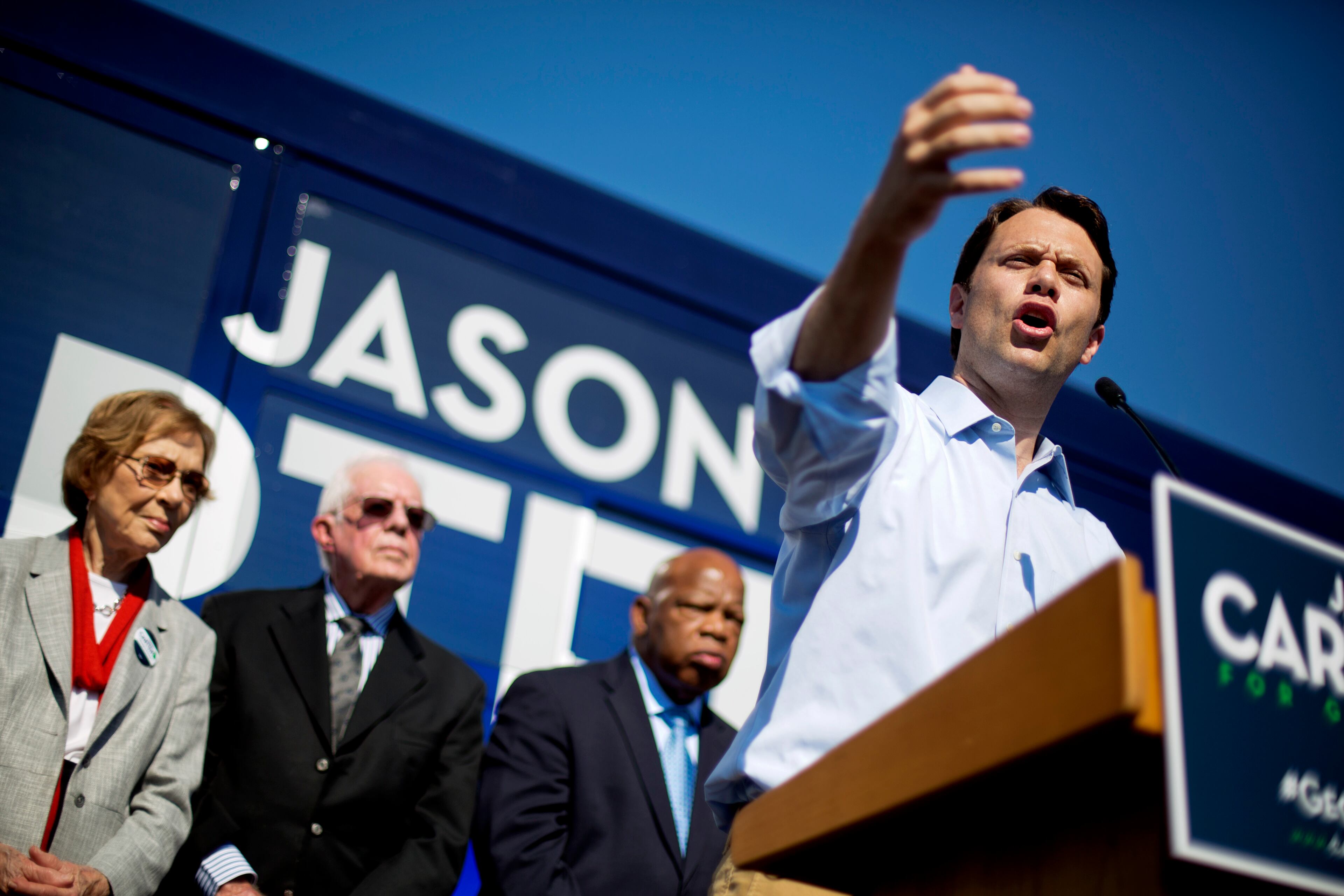 Georgia Democratic gubernatorial candidate Jason Carter, right, speaks during a campaign stop as, his grandfather, former President Jimmy Carter and wife Rosalynn, rear center and left, look on with Rep. John Lewis, D-Ga., Monday, Oct. 27, 2014, in Columbus, Ga. (AP Photo/David Goldman)