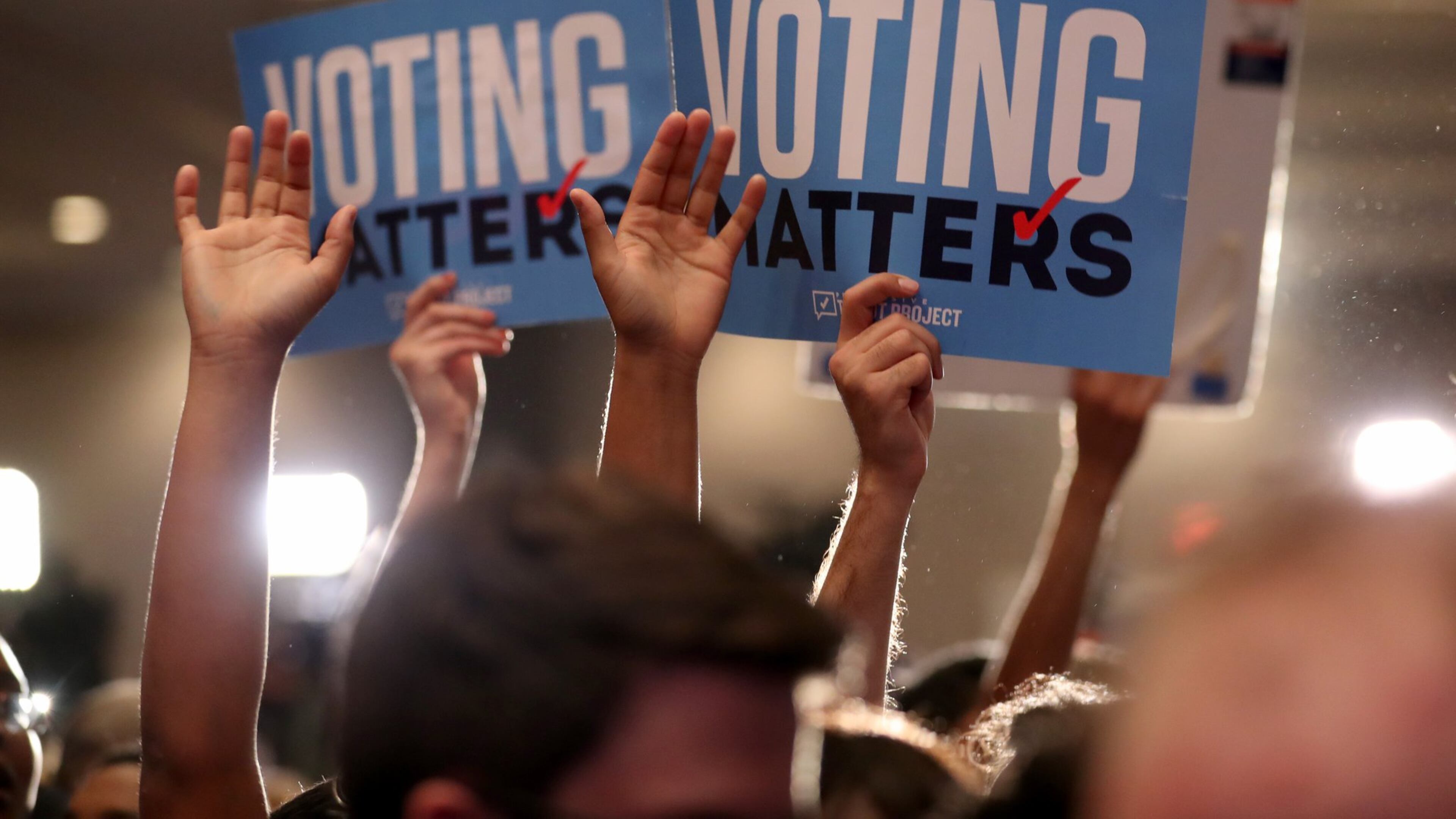 Jon Ossoff supporters hold Voting Matters signs in June 2017 in Atlanta. Their candidate lost the 6th Congressional District runoff -- but it was close, which is highly unusual in Georgia. JASON GETZ / AJC