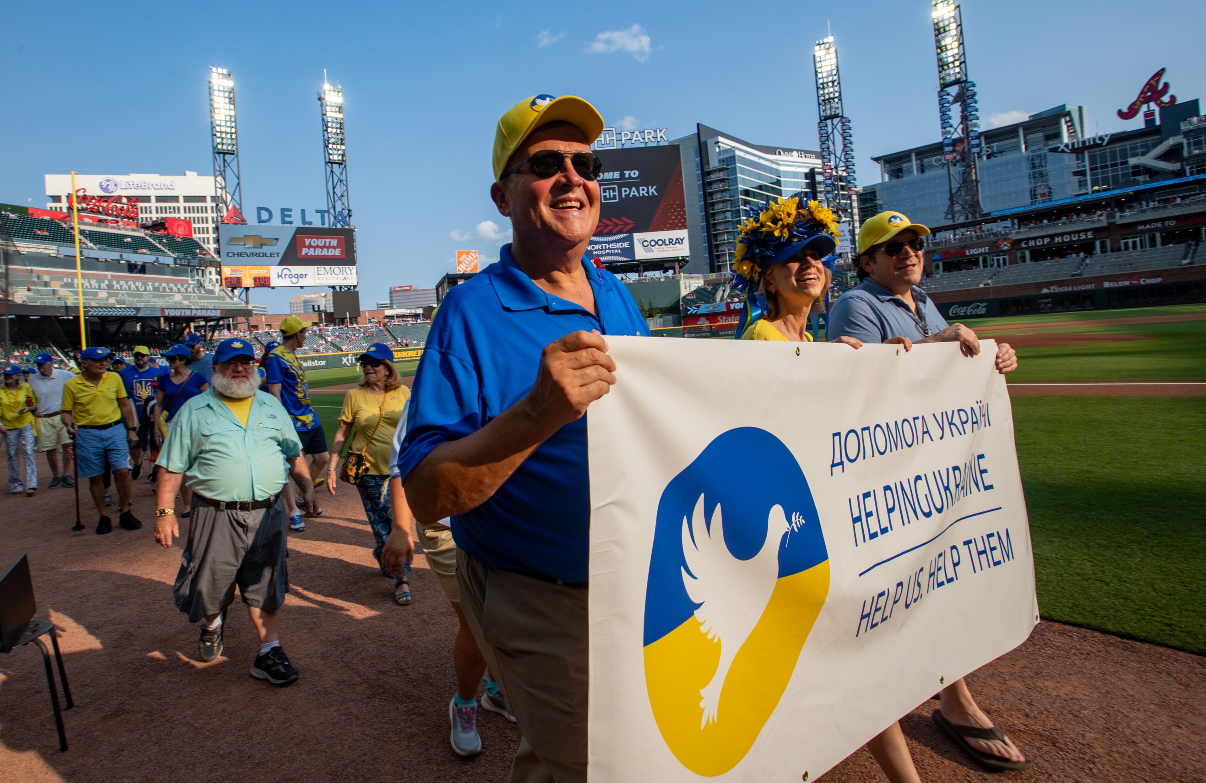 Helping Ukraine founder Emory Morsberger leads supporters in a pre-game parade around the field before the Braves vs Rockies game gets started on Friday, June 16, 2023. (Jenni Girtman for The Atlanta Journal-Constitution)