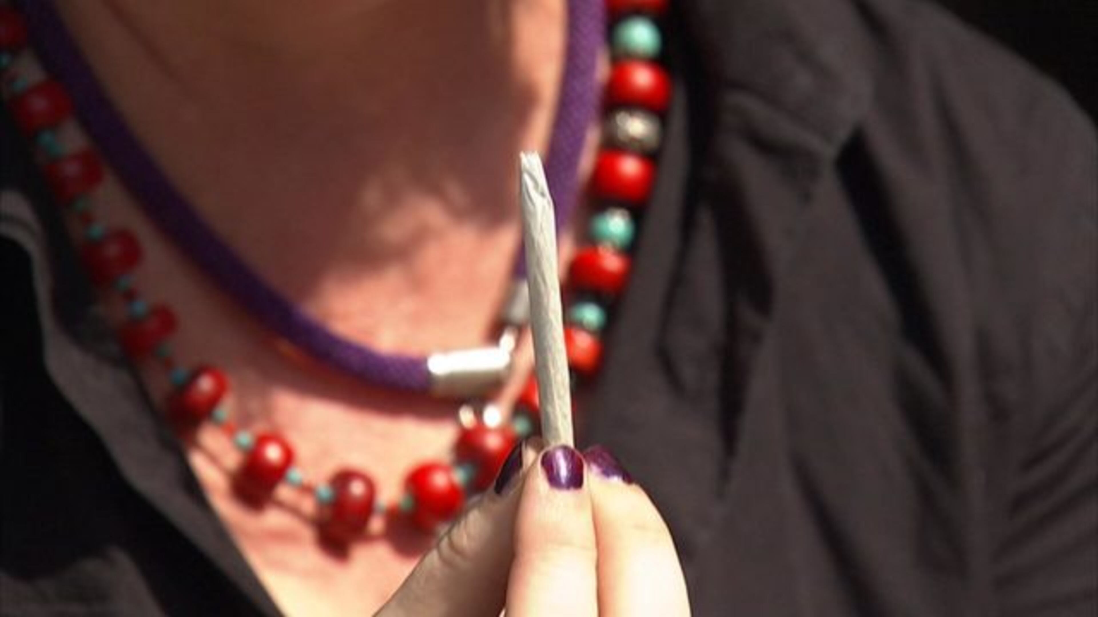 A free pot giveaway organizer holds a joint. (George Colli, Cox Media Group Washington News Bureau)