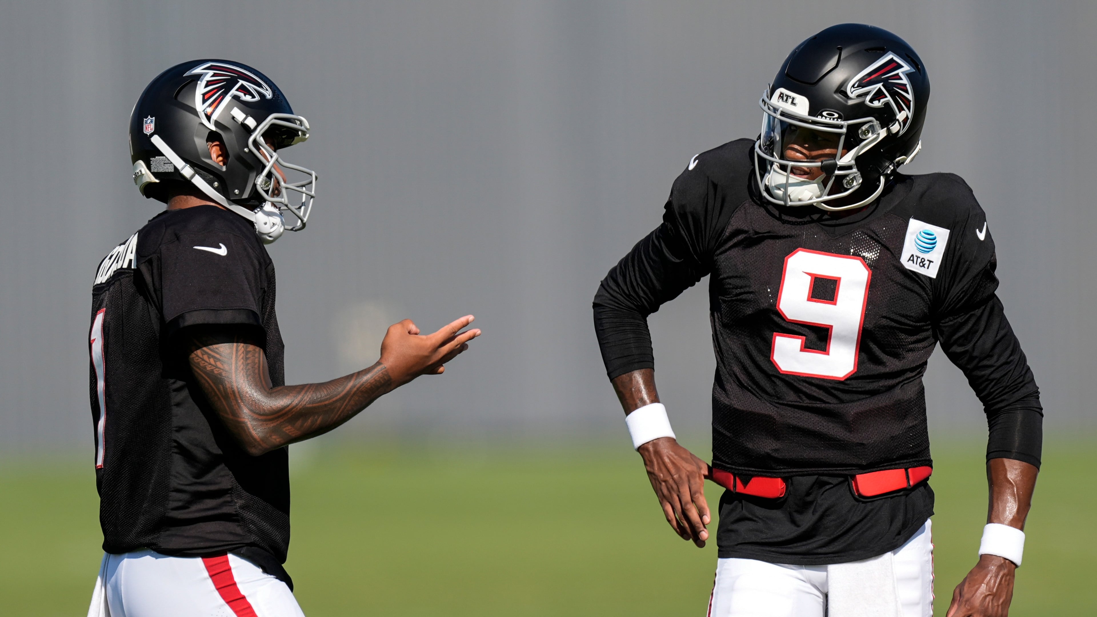 Atlanta Falcons quarterback Michael Penix Jr. (9) and Tua Tagovailoa speak during a Atlanta Falcons training camp, Monday, Aug. 3, 2026, in Flowery Branch, Ga. (AP Photo/Mike Stewart)