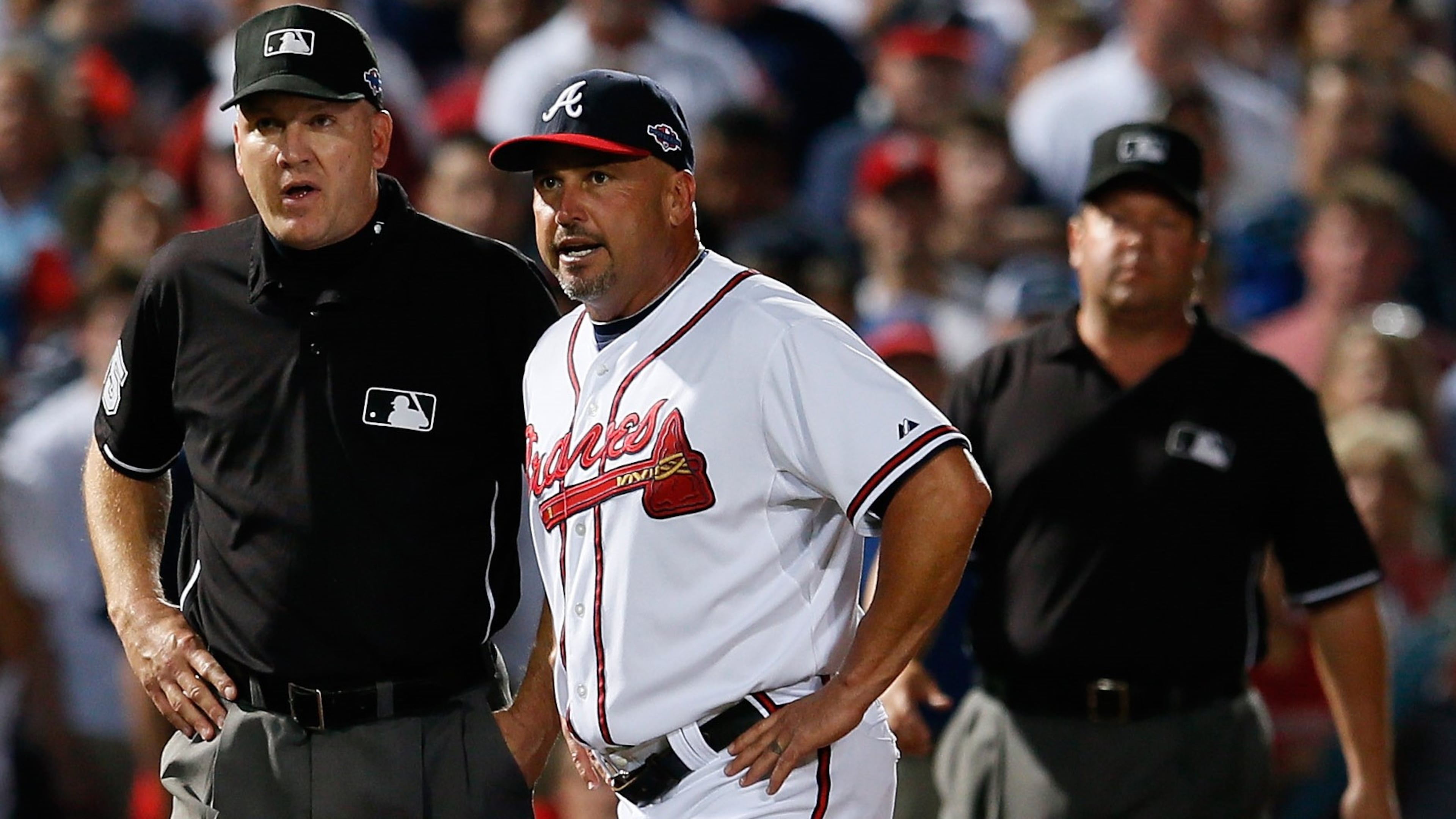In this October 2012 photo, Fredi Gonzalez argues an infield fly ruling in the eighth inning with third base umpire Jeff Nelson and left field umpire Sam Holbrook while taking on the St. Louis Cardinals during the National League Wild Card playoff game at Turner Field in Atlanta, Georgia. (Kevin C. Cox/Getty Images)