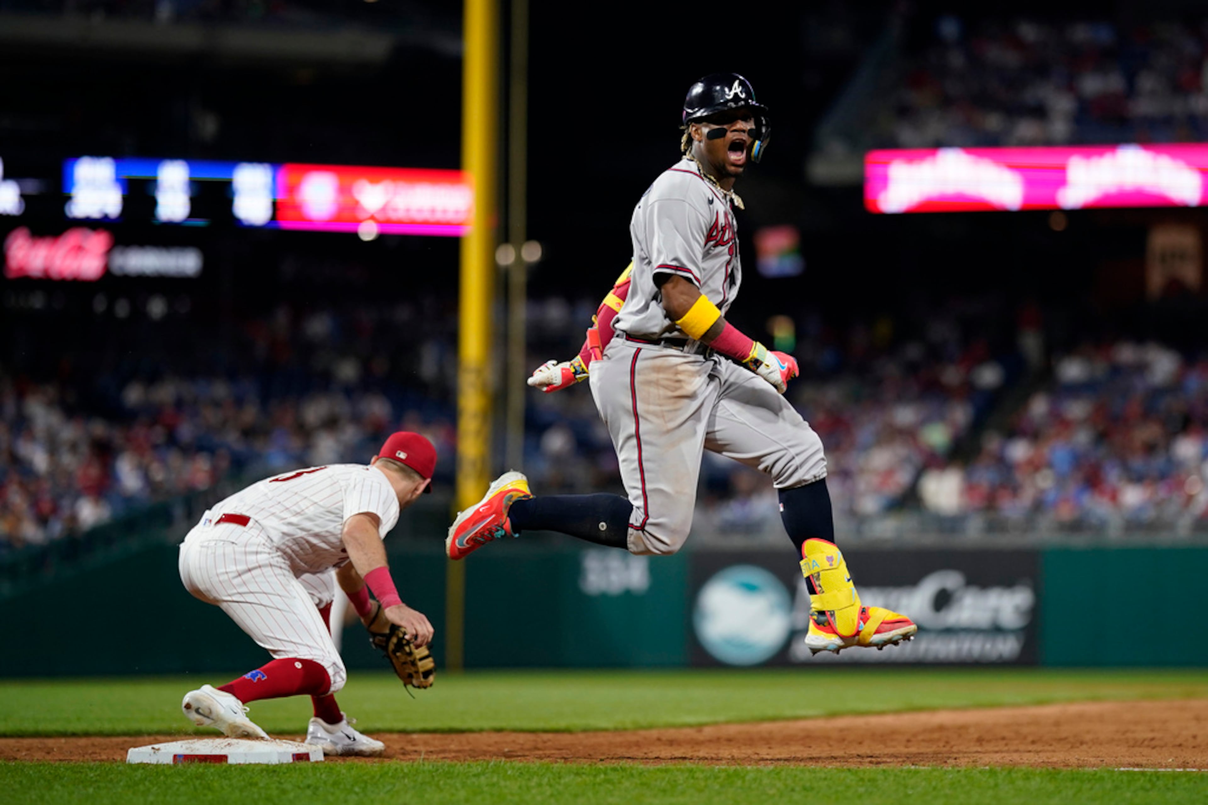 Atlanta Braves' Ronald Acuna Jr., right, reacts after beating the throw for a single past Philadelphia Phillies first baseman Kody Clemens during the ninth inning of a baseball game, Tuesday, June 20, 2023, in Philadelphia. (AP Photo/Matt Slocum)