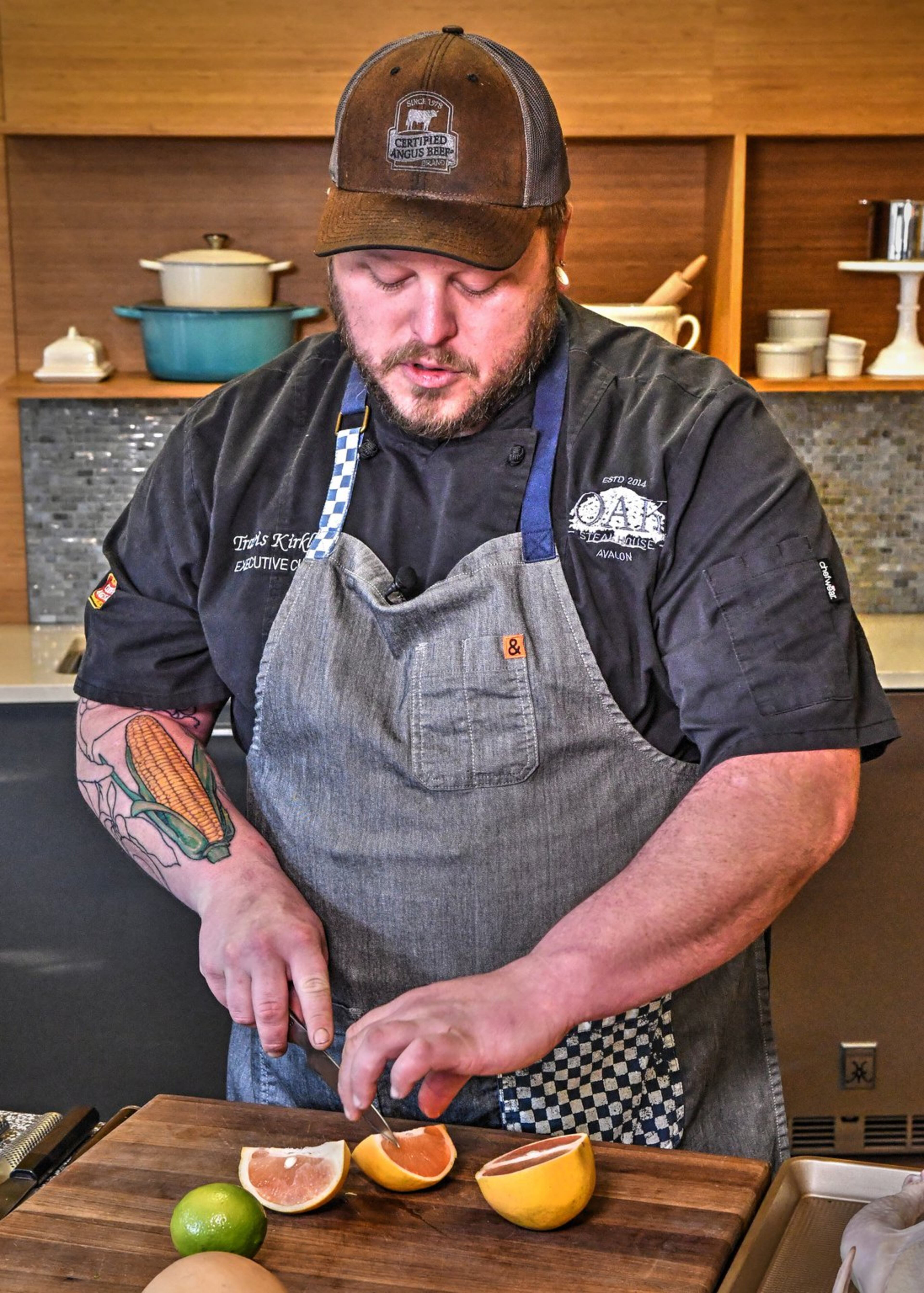 Executive chef Travis Kirkley of Oak Steakhouse in Alpharetta uses a serrated knife to cut a grapefruit. CONTRIBUTED BY CHRIS HUNT PHOTOGRAPHY