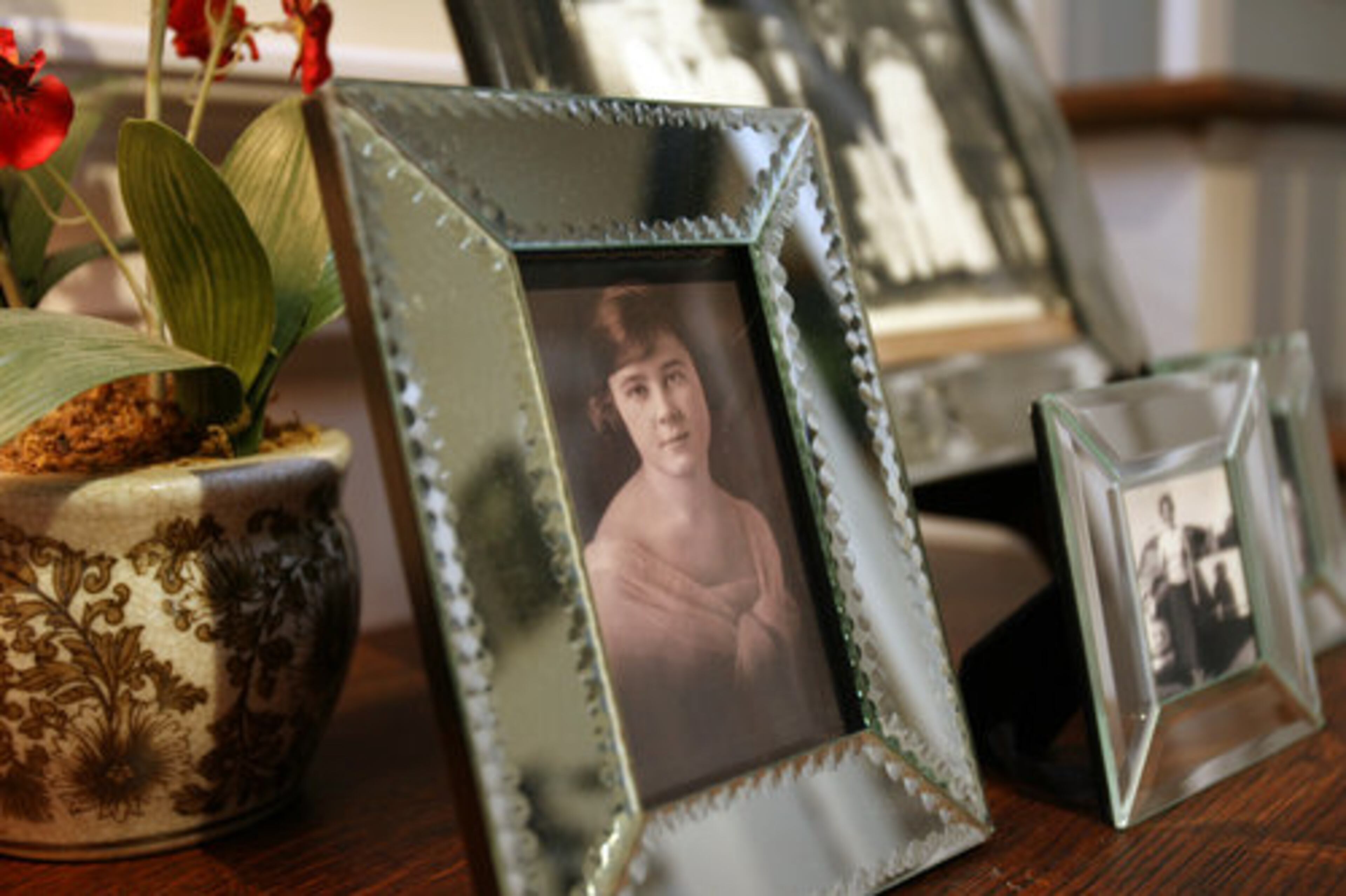 Susan Gibbs displays old family photographs in the hallway of the second floor.
