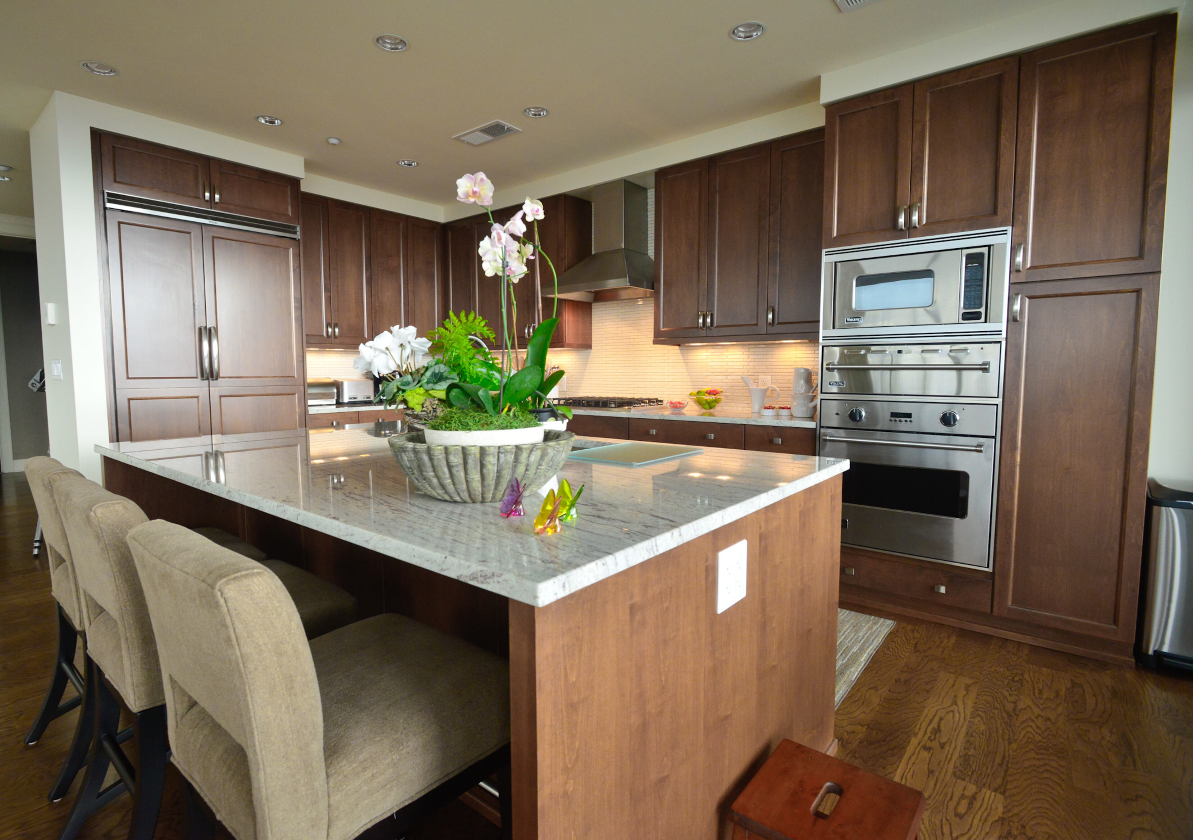 An island provides more seating and counter space in a kitchen that's equipped with Viking appliances. The cabinets received an updated look when the Kanovs replaced the hardware.