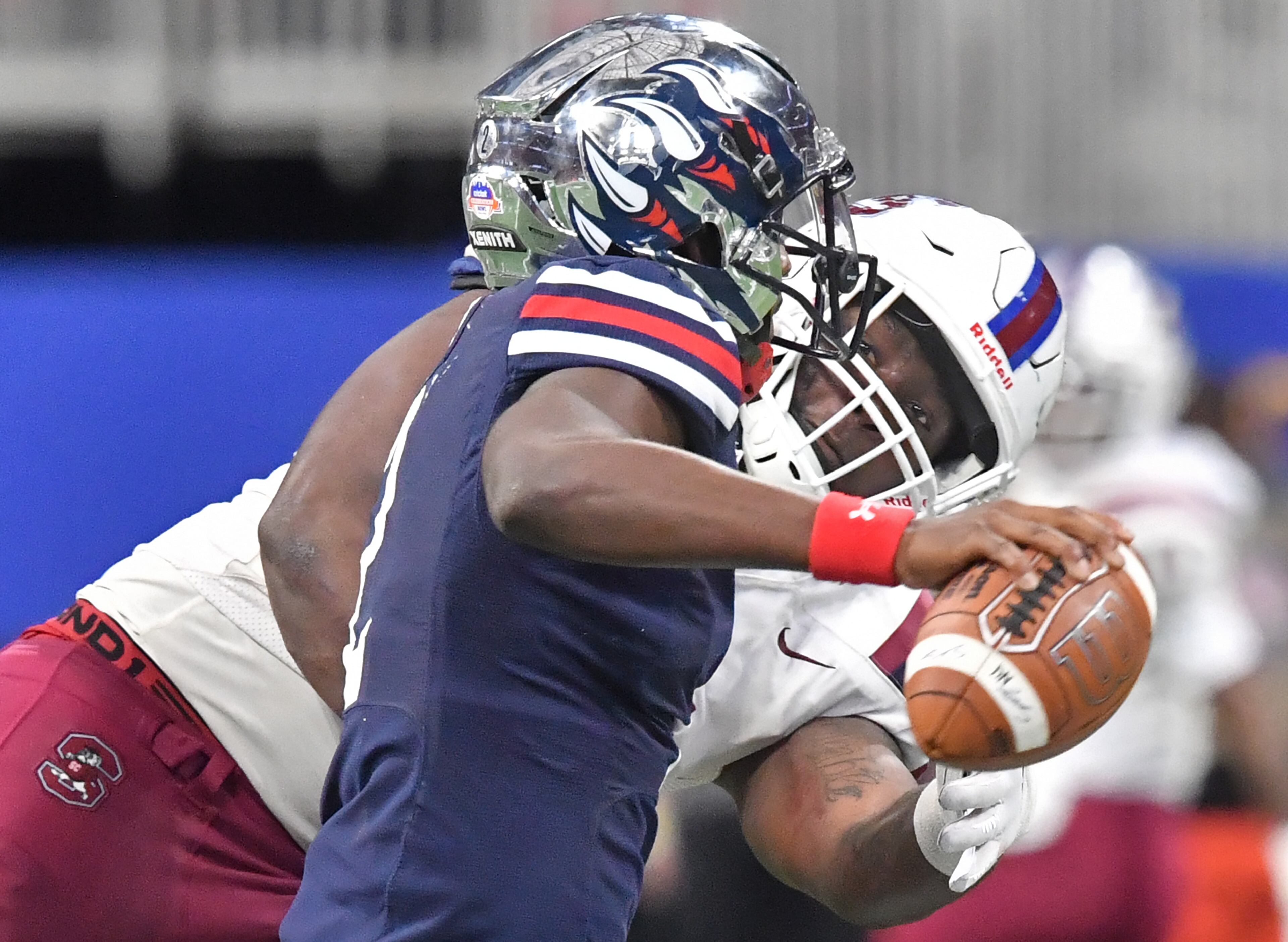 Jackson State's quarterback Shedeur Sanders (2) gets tackled by South Carolina State's linebacker Jablonski Green (34) during the second half of the 2021 Cricket Celebration Bowl at Mercedes-Benz Stadium in Atlanta on Saturday, December 18, 2021. South Carolina State won 31-10 over Jackson State. (Hyosub Shin / Hyosub.Shin@ajc.com)