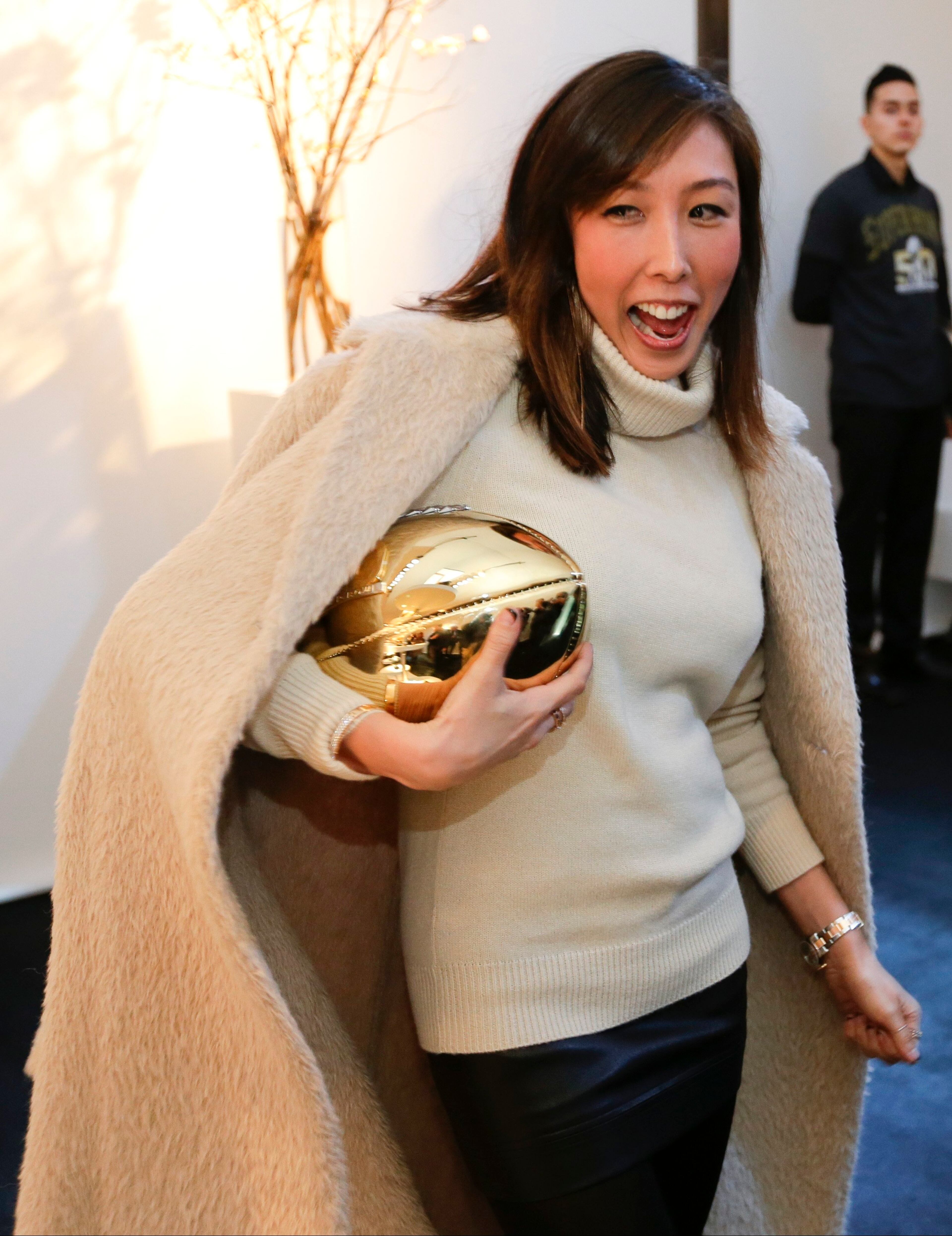 Jewelry Designer Cynthia Sakai holds a football she designed for Vita Fede at the unveiling of the CFDA Footballs Wednesday, Jan. 20, 2016, at the NFL headquarters in New York. In celebration of Super Bowl 50 and in support of the NFL Foundation, the NFL and the Council of Fashion Designers of America have collaborated on 50 Bespoke Designer Footballs created by CFDA Members. (AP Photo/Frank Franklin II)
