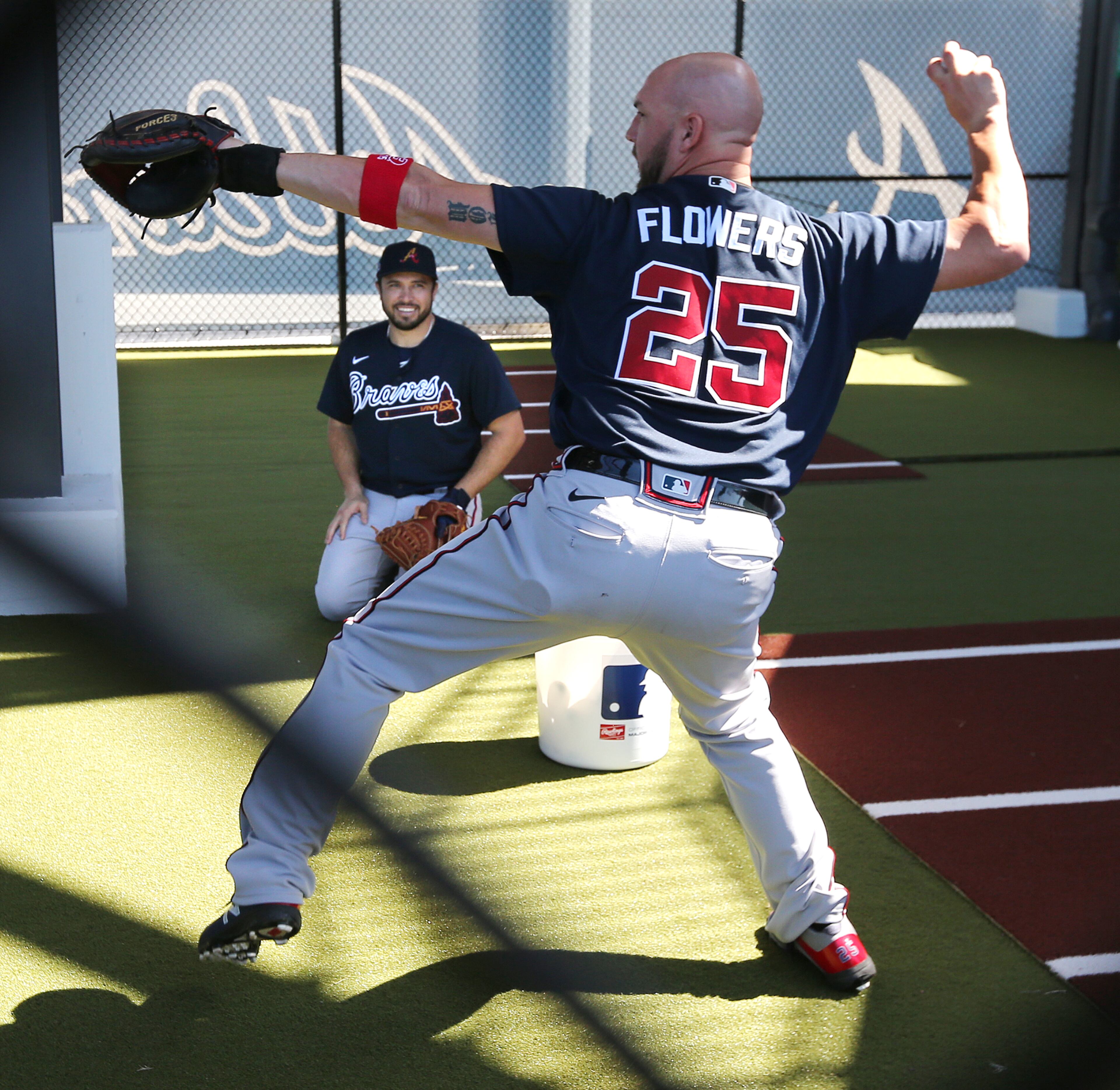 Braves catcher Tyler Flowers works on a drill in the bullpen with Travis D'Arnaud looking on during spring training on Saturday, Feb. 15, 2020, in North Port. Curtis Compton ccompton@ajc.com