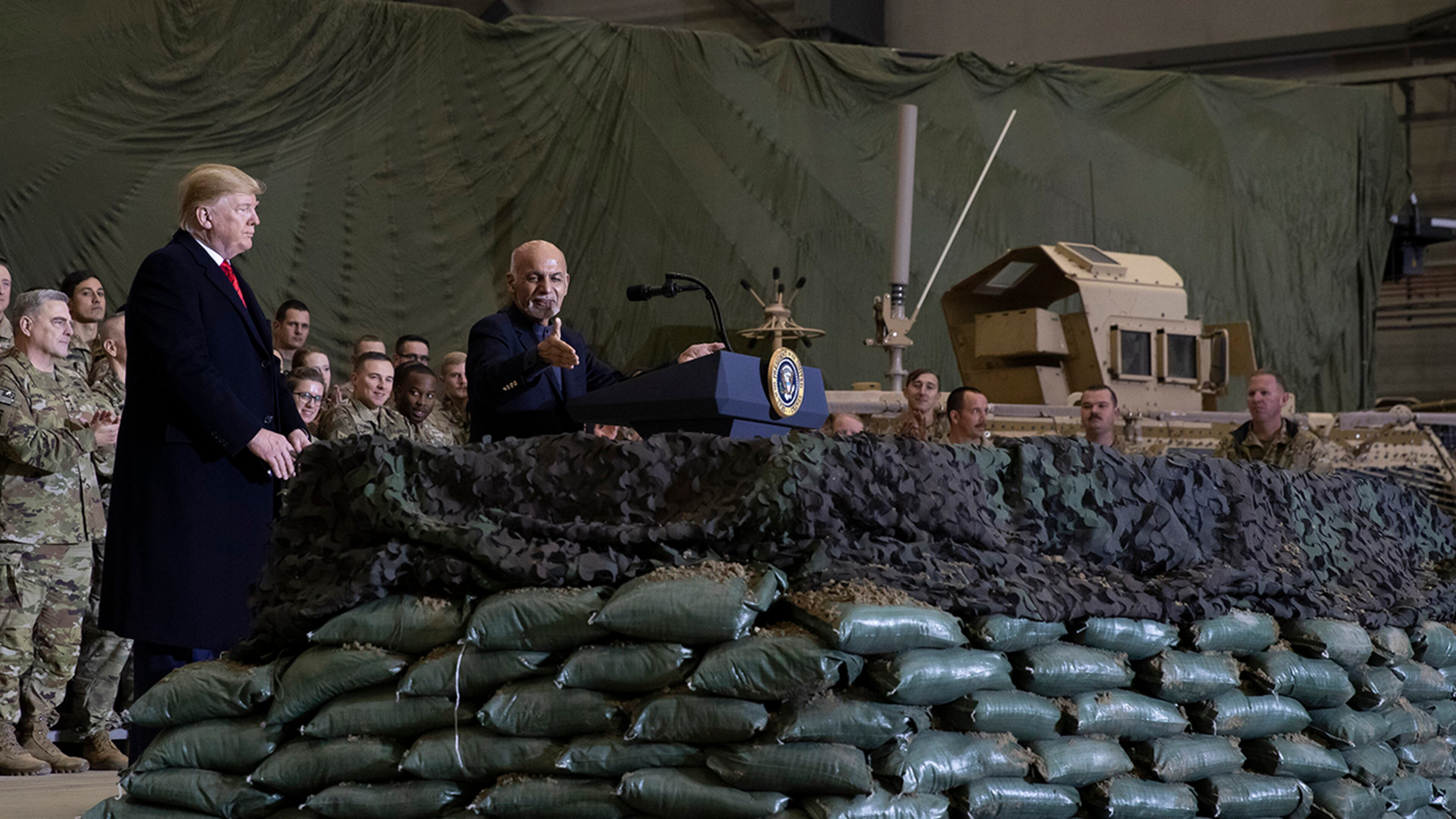 President Donald Trump, left, listens as Afghan President Ashraf Ghani addresses members of the military during Trump's surprise Thanksgiving Day visit, Thursday, Nov. 28, 2019, at Bagram Air Field, Afghanistan. (AP Photo/Alex Brandon)