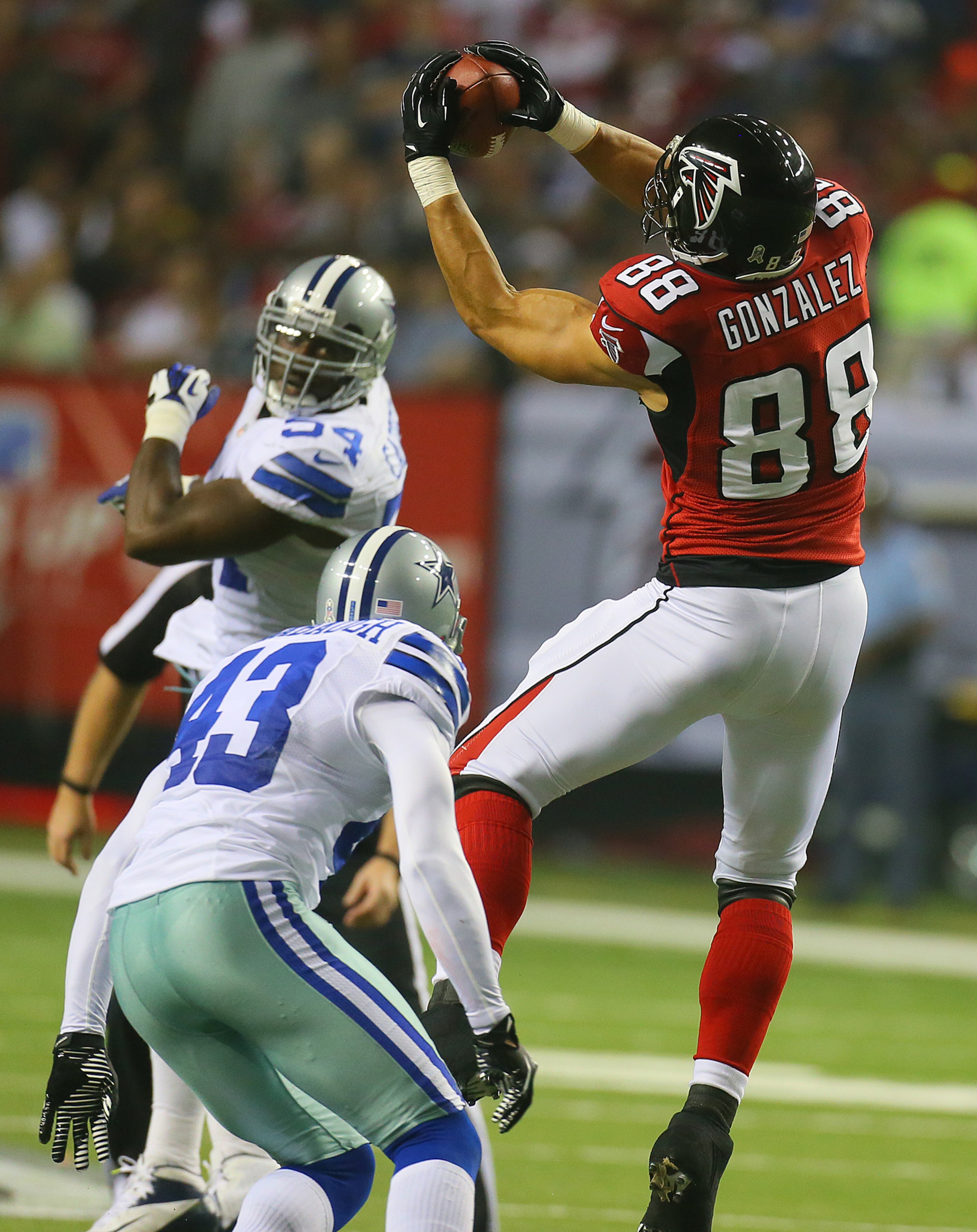 110412 ATLANTA: Falcons tight end Tony Gonzalez makes a first down catch over Cowboys safety Gerald Sensabaugh during 1st half action at the Georgia Dome in Atlanta on Sunday, Nov. 4, 2012. CURTIS COMPTON / CCOMPTON@AJC.COM