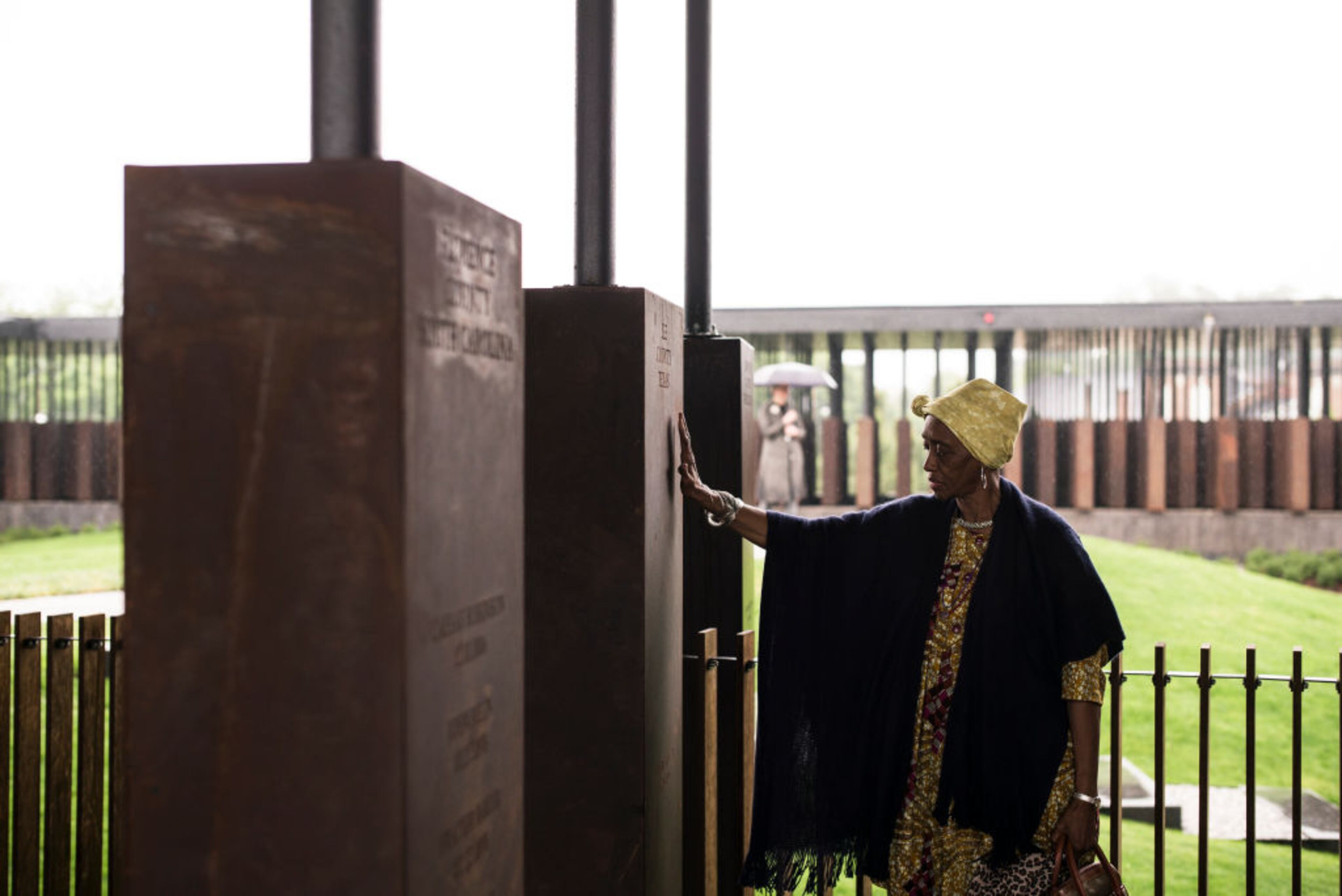 MONTGOMERY, AL - APRIL 26: Wretha Hudson, 73, discovers a marker commemorating lynchings in Lee County, Texas while visiting the National Memorial For Peace And Justice on April 26, 2018 in Montgomery, Alabama. Hudson, whose father's family came to Alabama from Lee County decades earlier, said the experience was overwhelming. "It's a combination of pride and strength, for my people. In our culture, rain is a sign of acceptance from our ancestors. So the rain is a sign of their acceptance for this day." The memorial is dedicated to the legacy of enslaved black people and those terrorized by lynching and Jim Crow segregation in America. Conceived by the Equal Justice Initiative, the physical environment is intended to foster reflection on America's history of racial inequality. (Photo by Bob Miller/Getty Images)