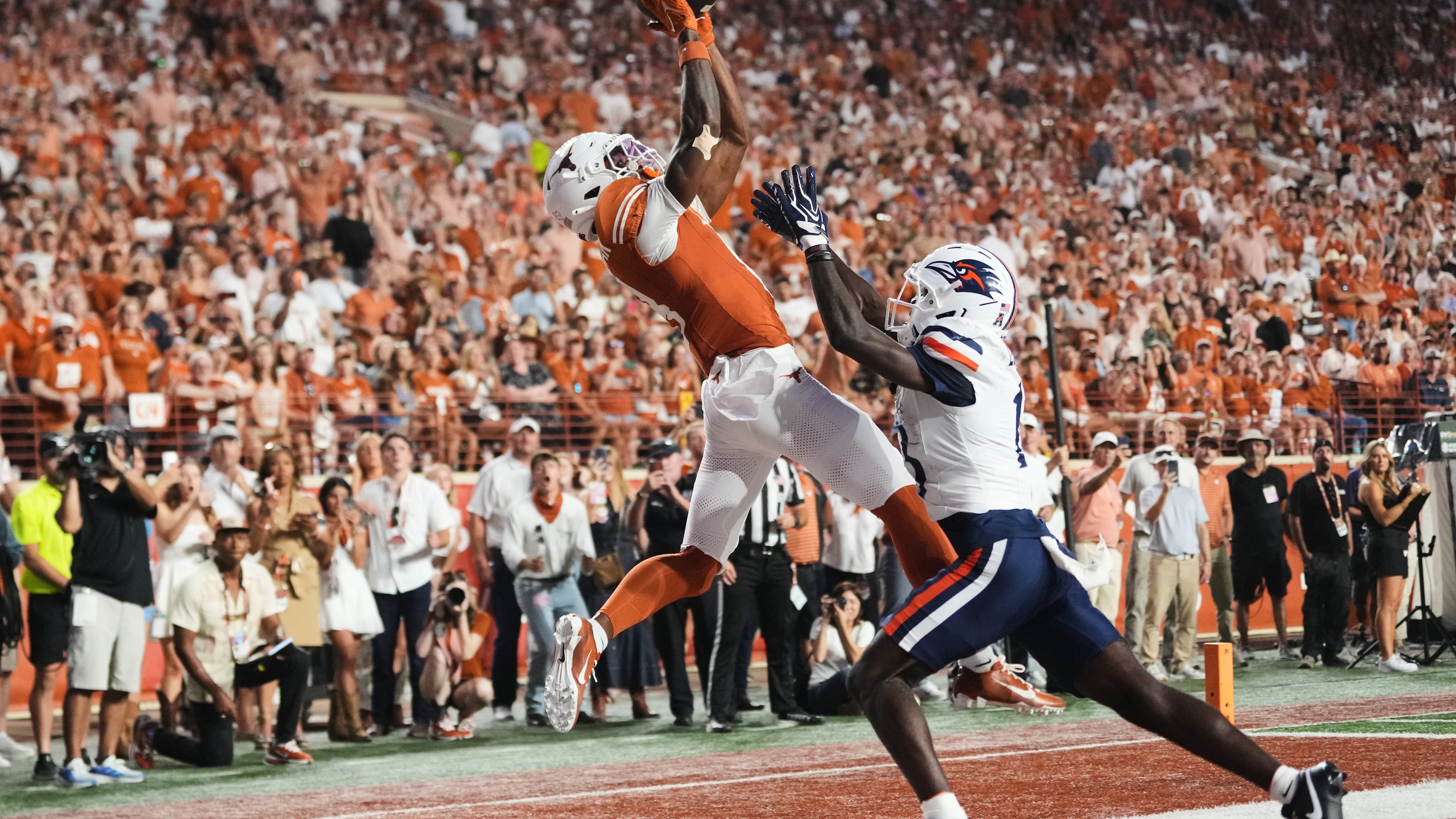 Texas wide receiver Cam Coleman, left, catches a touchdown pass as UTSA cornerback RJ Lester Jr., right, defends during the first half of an NCAA college football game in Austin, Texas, Saturday, Sept. 19, 2026. (AP Photo/Eric Gay)