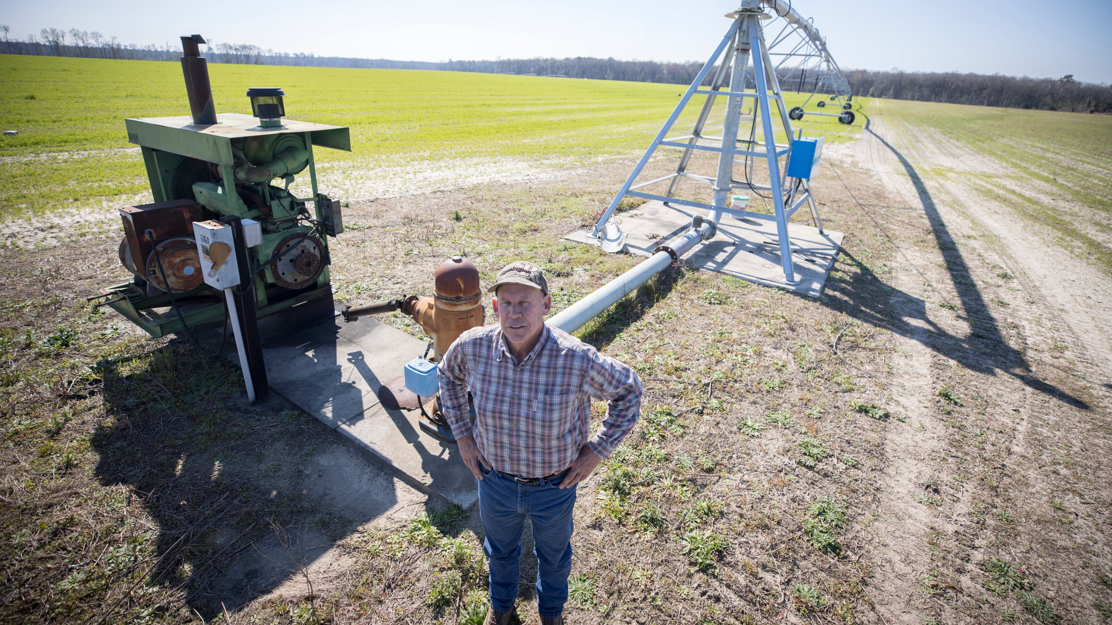 Ray Davis, a Bulloch County farmer, stands near one of his wells and pivots that irrigate part of his 1,100 acres on Wednesday, Feb. 21, 2024, near Brooklet, Ga. Davis is concerned that a plan to pump groundwater to supply Hyundai's Metaplant EV factory will compromise local wells like his. (AJC Photo/Stephen B. Morton)