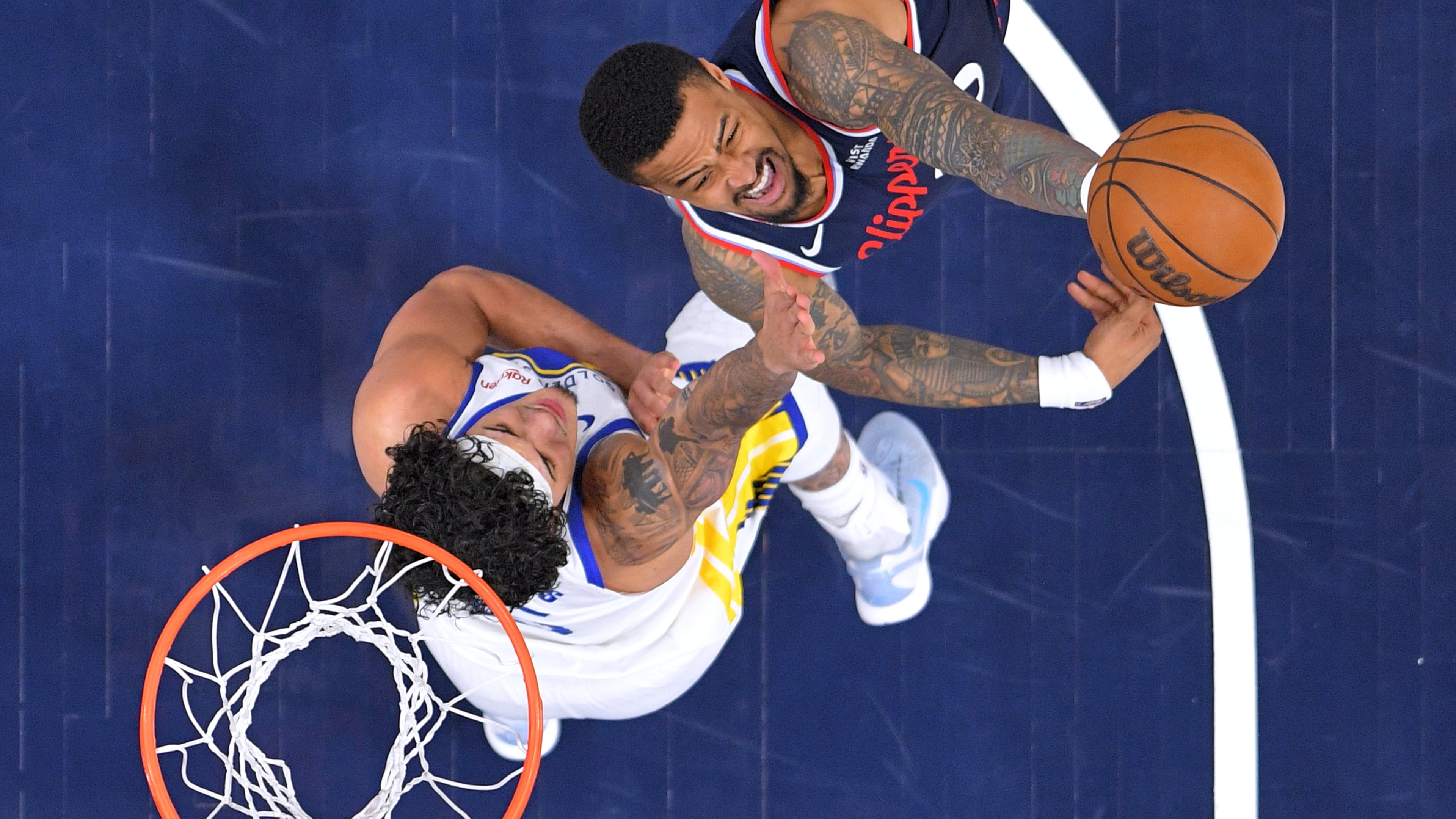 FILE - LA Clippers forward John Collins, right, shoots as Golden State Warriors forward Gui Santos defends during the first half of an NBA play-in tournament basketball game April 15, 2026, in Inglewood, Calif. (AP Photo/Mark J. Terrill, File)
