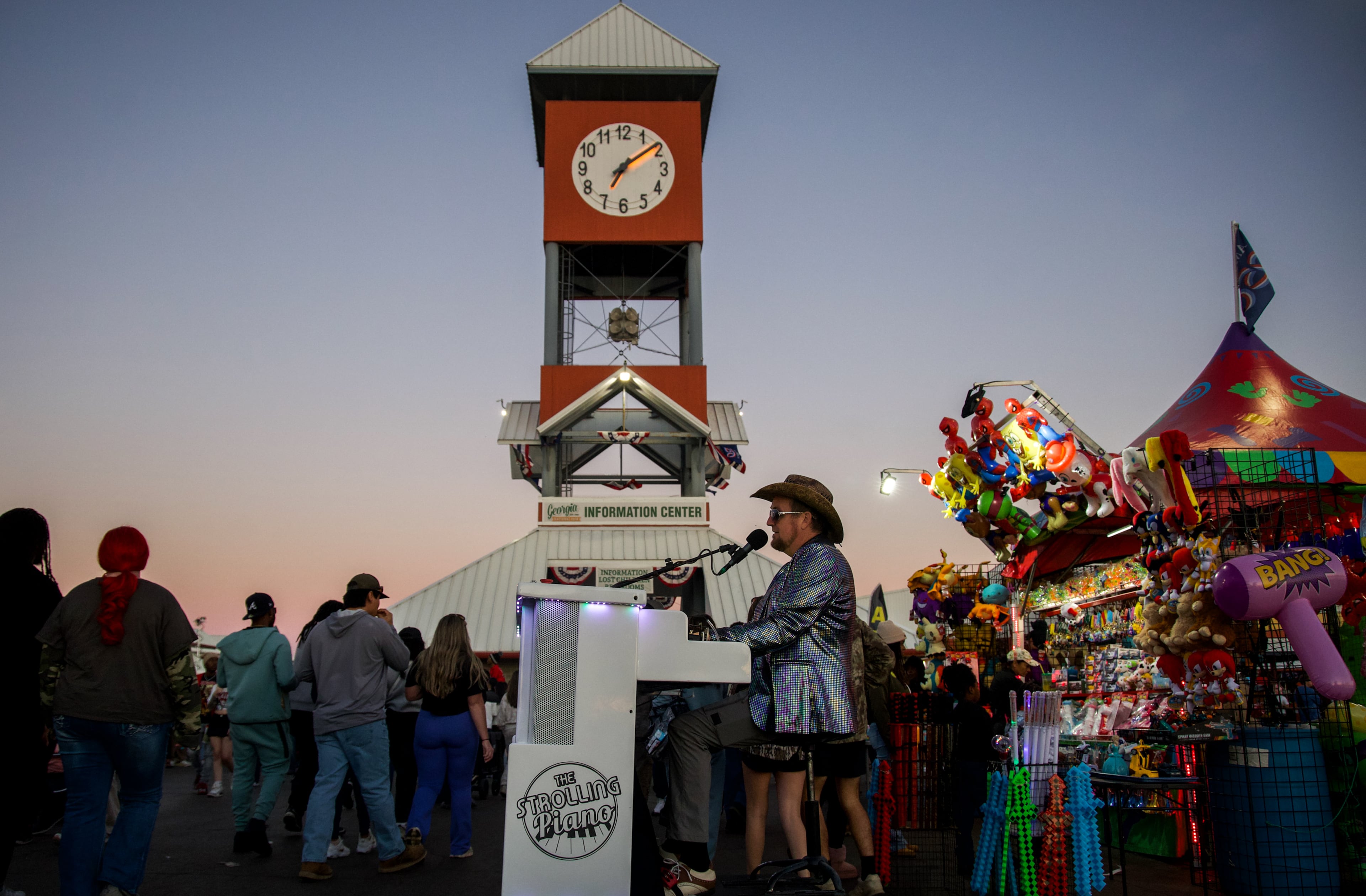 The Strolling Piano rolls past the clock tower at the Georgia National Fair in Perry, Georgia, on Oct. 17, 2026. The Strolling Piano is a fully mobile piano that rolls around the fair grounds each day. (Emily Laycock/UGA Photojournalism Workshop)