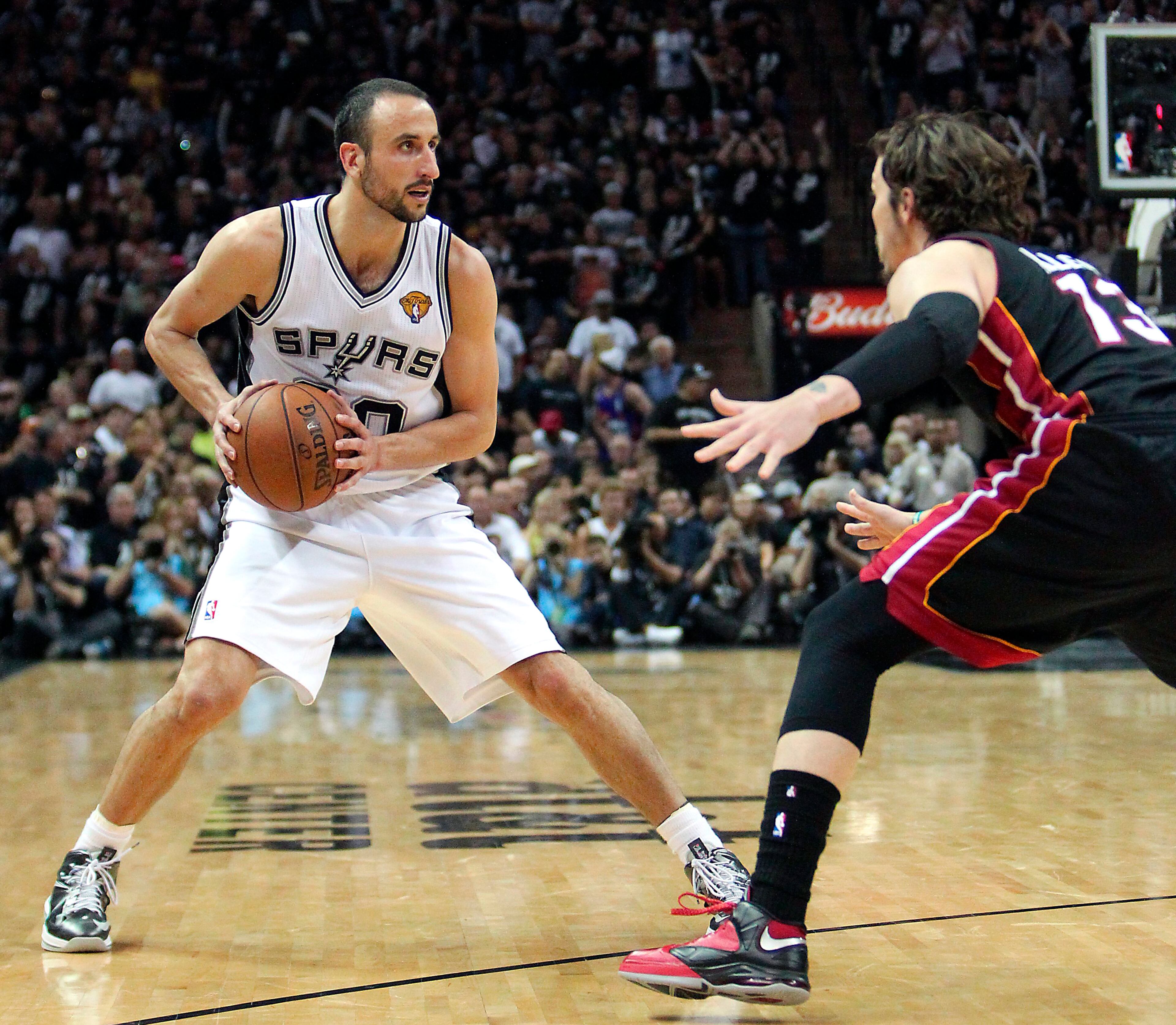 San Antonio guard Manu Ginobili, left, of Argentina, looks to pass against Miami Heat forward Mike Miller during the fourth quarter of Game 5 in the NBA Finals in San Antonio on Sunday, June 16, 2013.