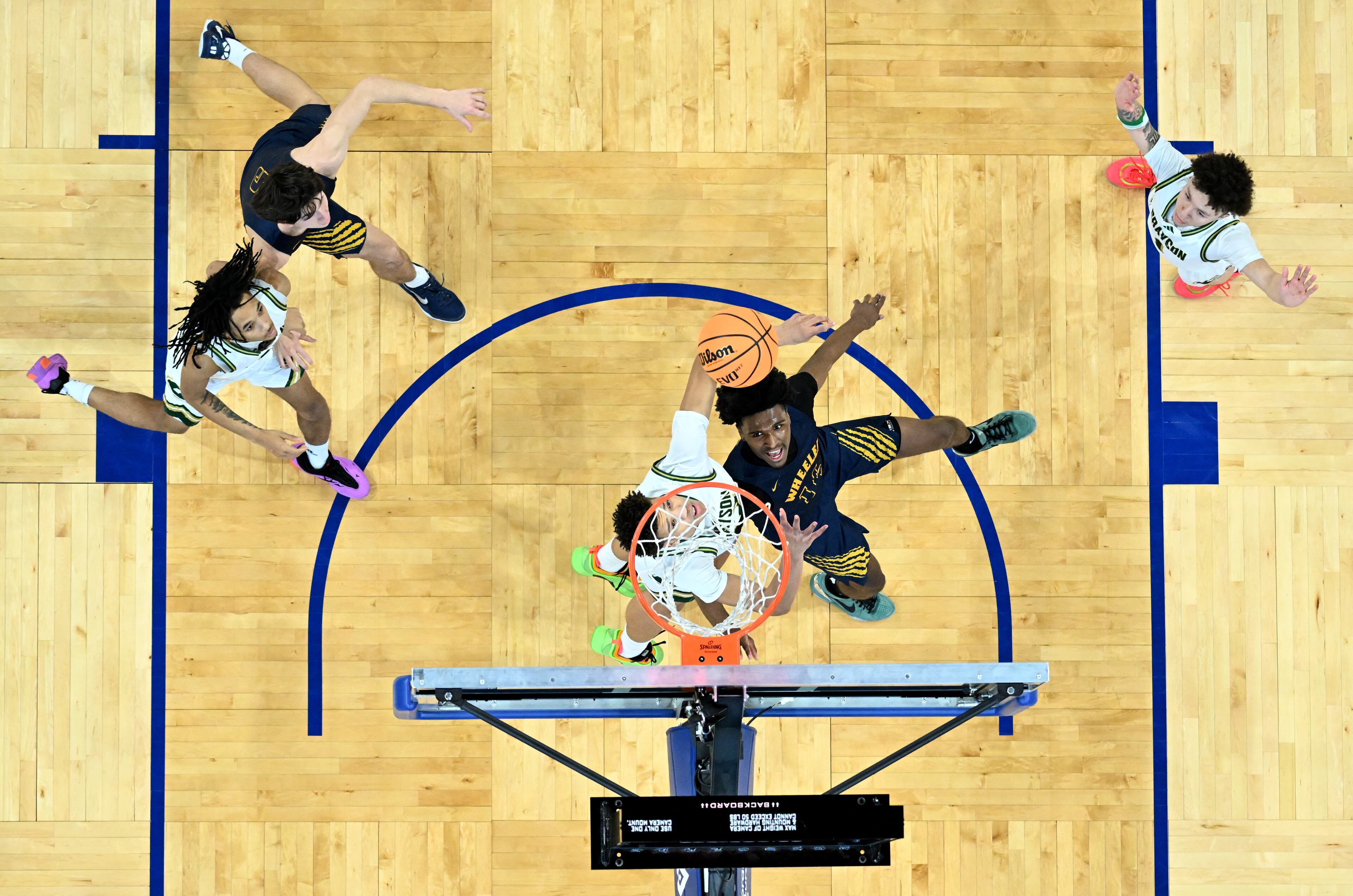 Wheeler's Mansur Mcclain (14) shoots against Grayson's Jayvon Rampersant (23) during the second half of the GHSA Class 6A Boys State Basketball playoffs game at the Georgia State Convocation Center, Saturday, March 1, 2025, in Atlanta. Wheeler won 68-53 over Grayson. (Hyosub Shin / AJC)