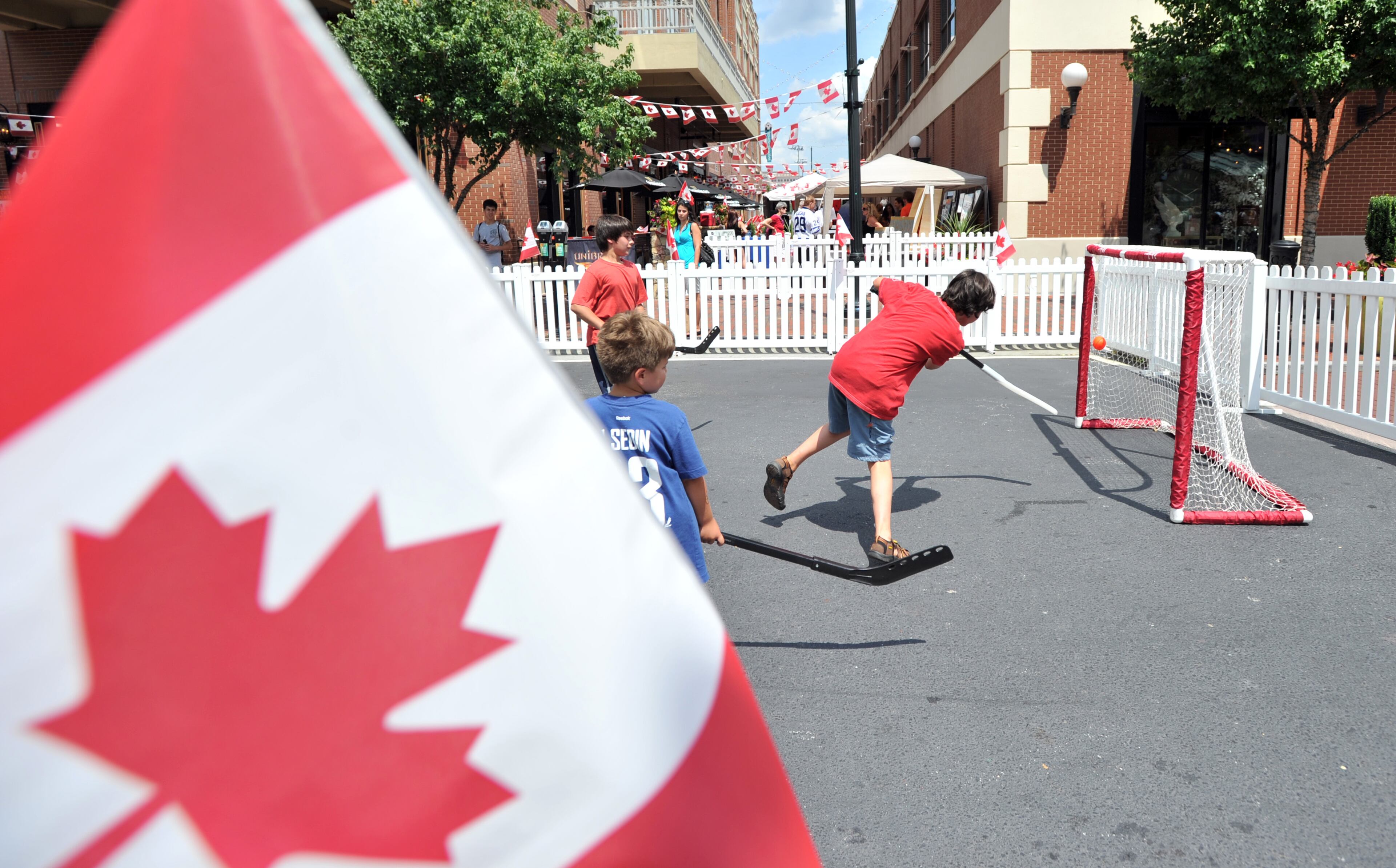 Kids play street hockey during the 8th Annual Canada Fest Presented by Unibroue and ATLCanadians.com at Meehan's Public House at Atlantic Station in Atlanta Saturday, June 29, 2013.
