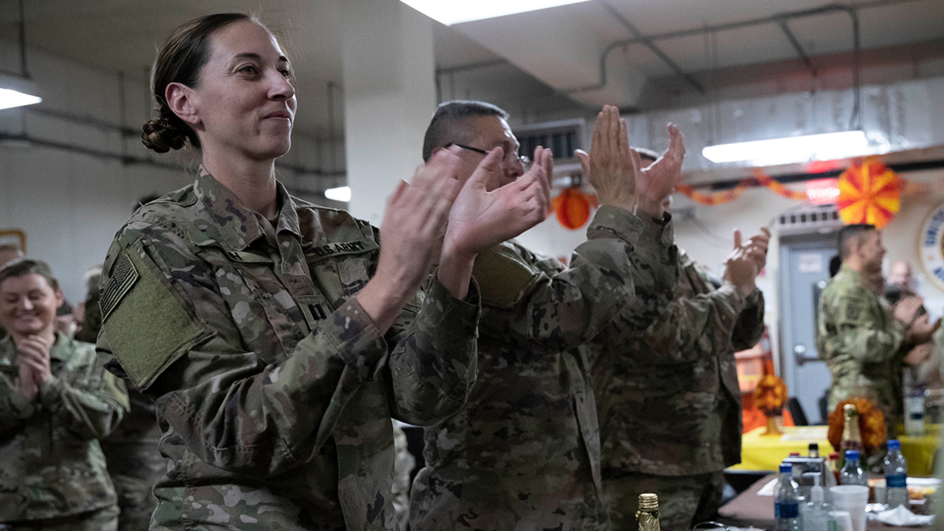 Members of the military applaud as President Donald Trump speaks at a dinning facility during a surprise Thanksgiving Day visit, Thursday, Nov. 28, 2019, at Bagram Air Field, Afghanistan. (AP Photo/Alex Brandon)
