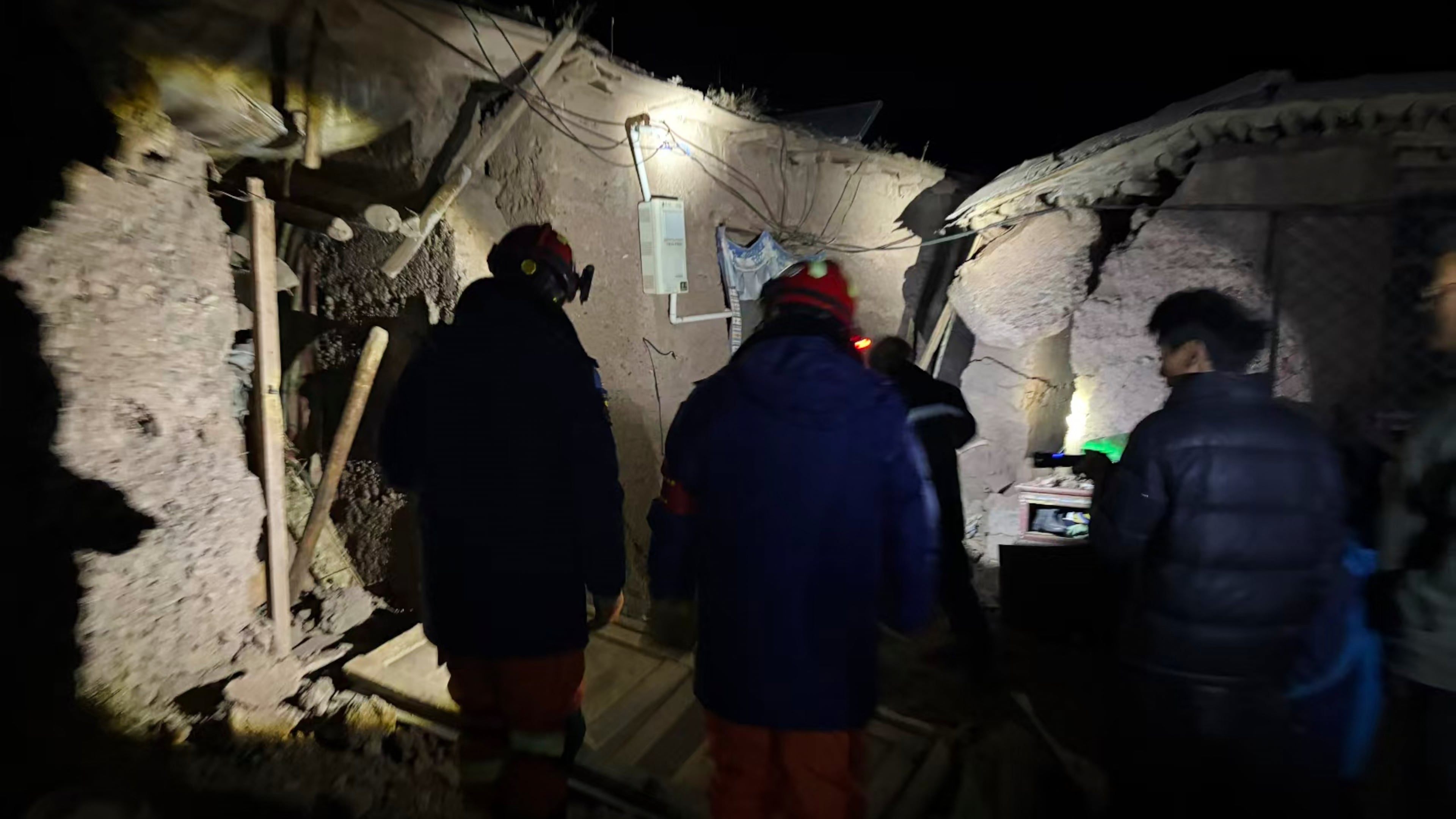 In this photo released by Xinhua News Agency, firefighters inspect an earthquake-hit village houses in Baqen County of Nagqu City in China's Tibet autonomous region, on Friday, Oct. 23, 2026. (Xinhua via AP)