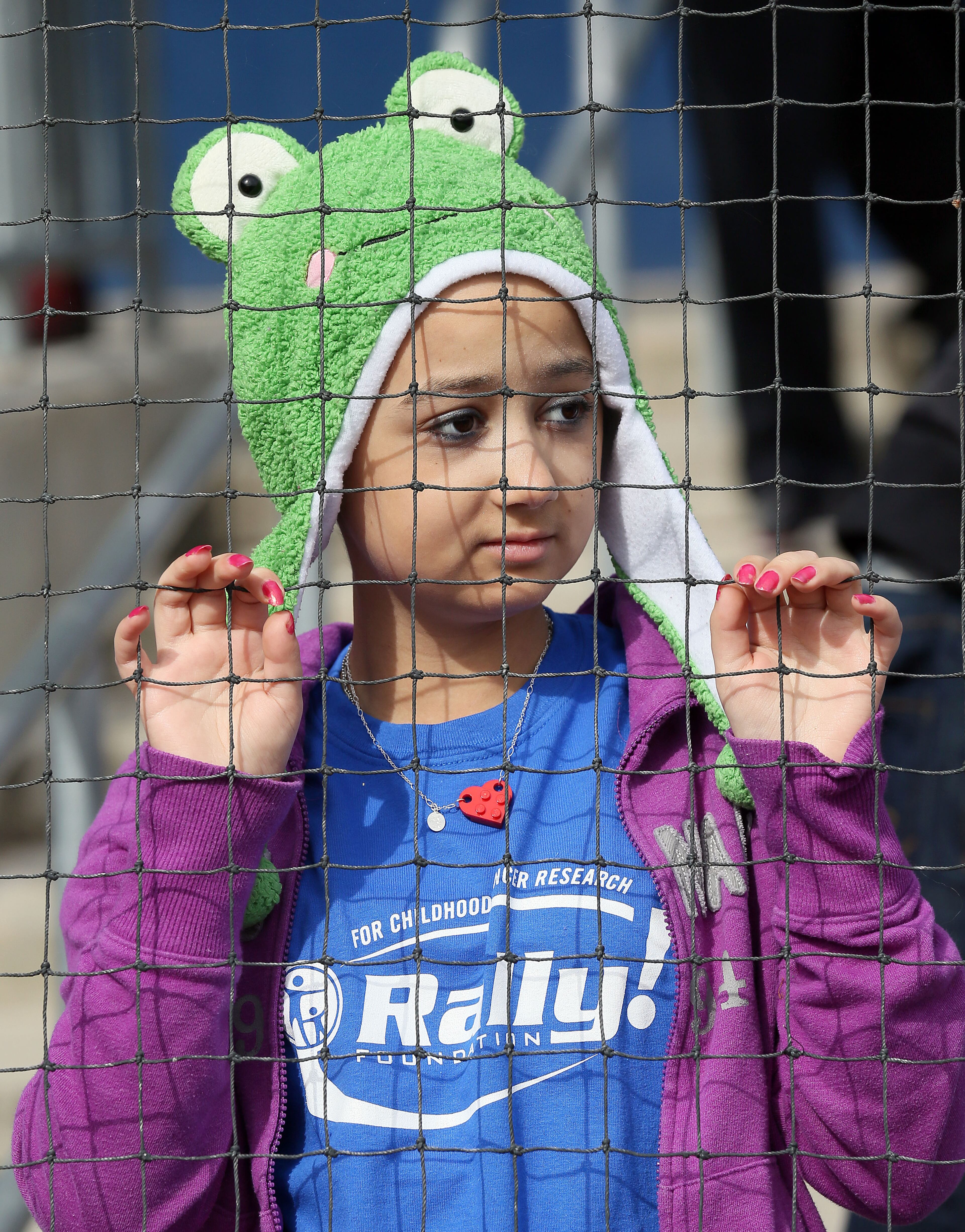 Lindsay Simmons(age 14) watches the 5th annual Brian McCann Rally Foundation Celebrity Softball Game at Coolray field in Lawrenceville on Saturday November 9th, 2013. Bert's Big Bats team played against Tug's Triple Threat in the event that raised funds for childhood cancer research.