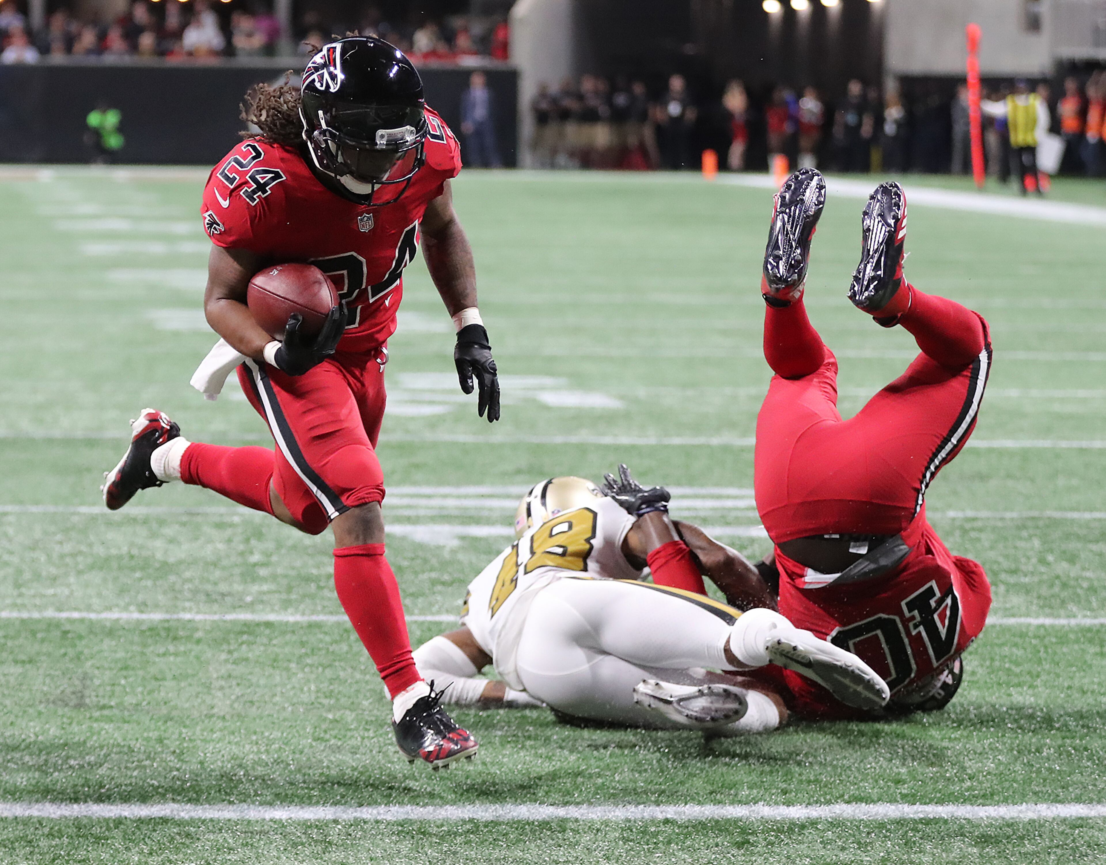 December 7, 2017 Atlanta: Falcons fullback Derrick Coleman levels Saints safety Vonn Bell opening the hole for running back Devonta Freeman to score a touchdown to take a 10-3 lead during the second quarter in a NFL football game on Thursday, December 7, 2017, in Atlanta. Curtis Compton/ccompton@ajc.com
