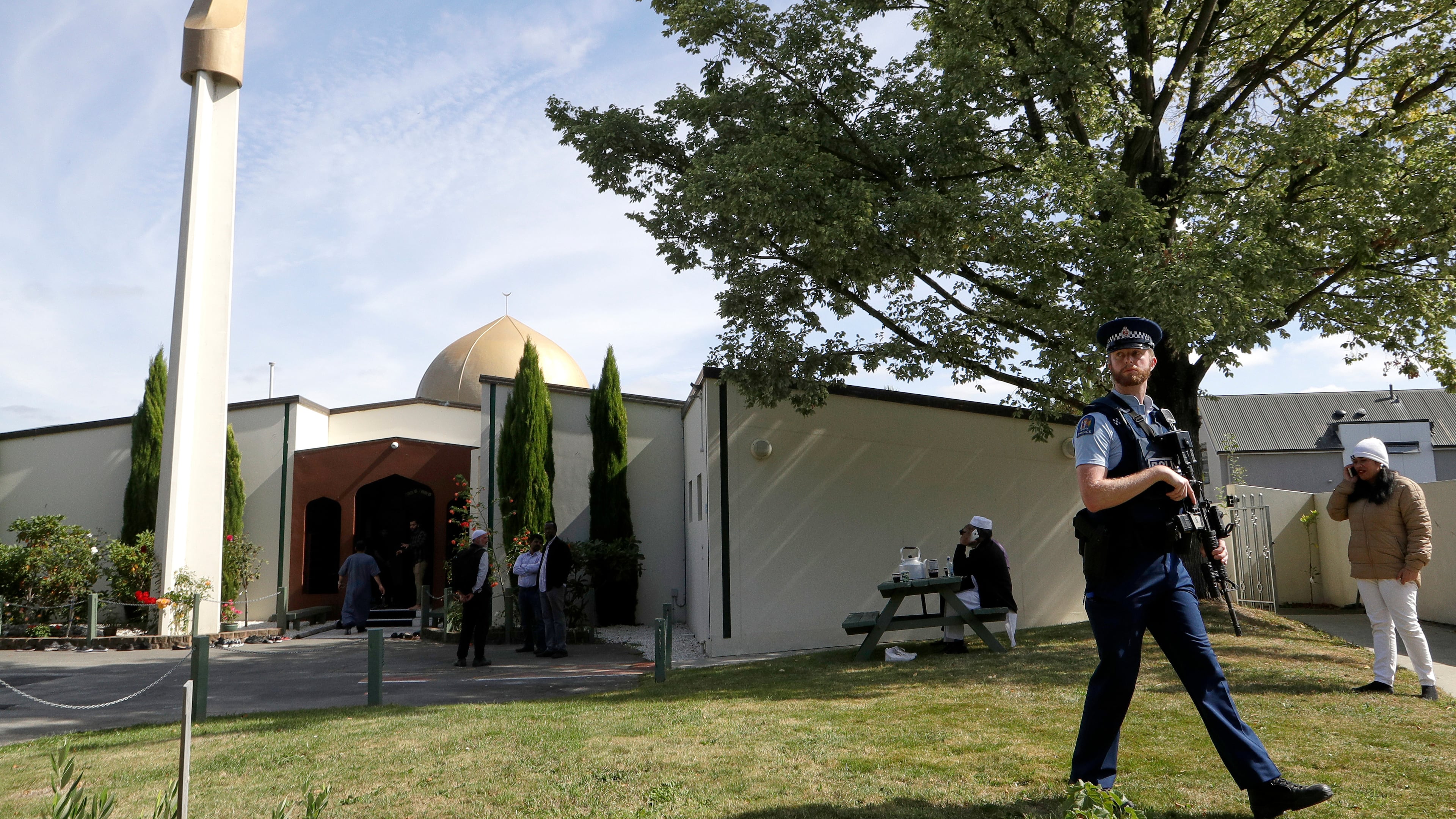 FILE - An armed policeman patrols the grounds at the Al Noor mosque following the previous week's mass shooting in Christchurch, New Zealand, on March 23, 2019. (AP Photo/Mark Baker, File)