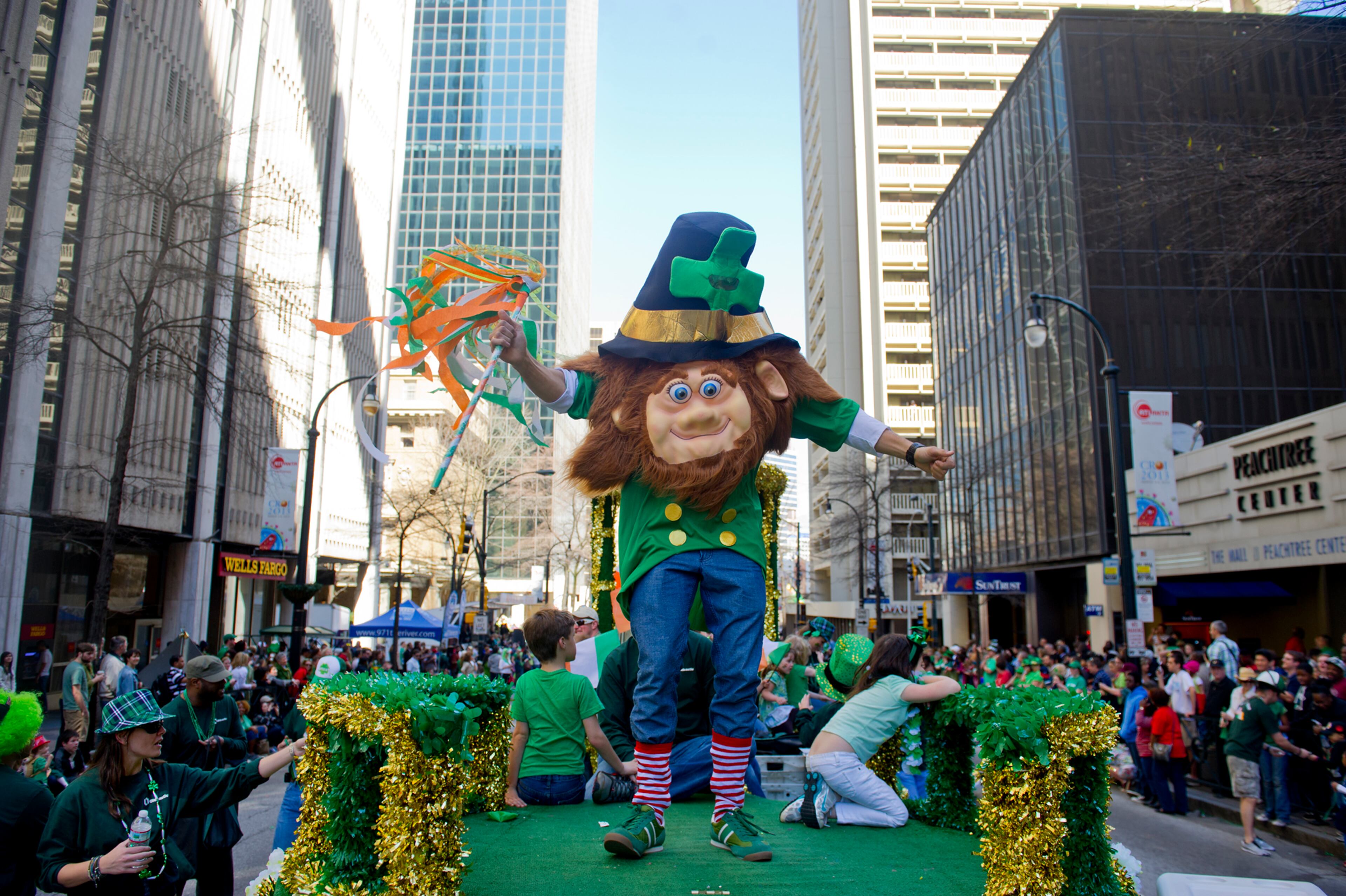 Dressed as a leprechaun, Diego Correa (center) dances and waves to the crowd on Peachtree Street during the 131st Atlanta St. Patrick's Day Parade on Saturday March 16, 2013.
