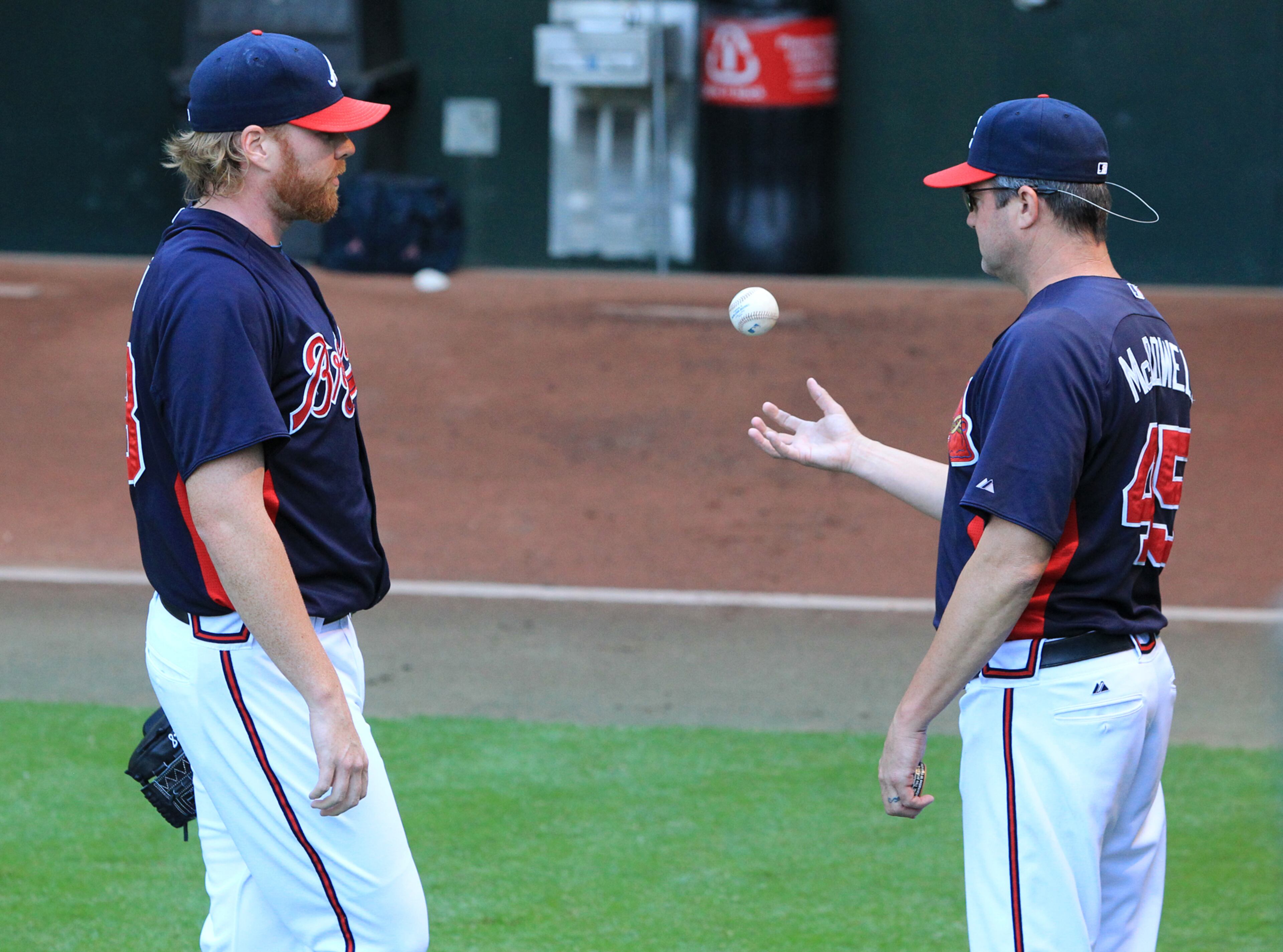 Atlanta Braves pitcher Tommy Hanson confers with pitching coach Roger McDowell while throwing in the bull pen trying to come back from a sore shoulder before the Braves take on the Marlins at Turner Field in Atlanta on Wednesday, Sept. 14, 2011. The Braves could use his services come October if he is able to come back. Curtis Compton ccompton@ajc.com