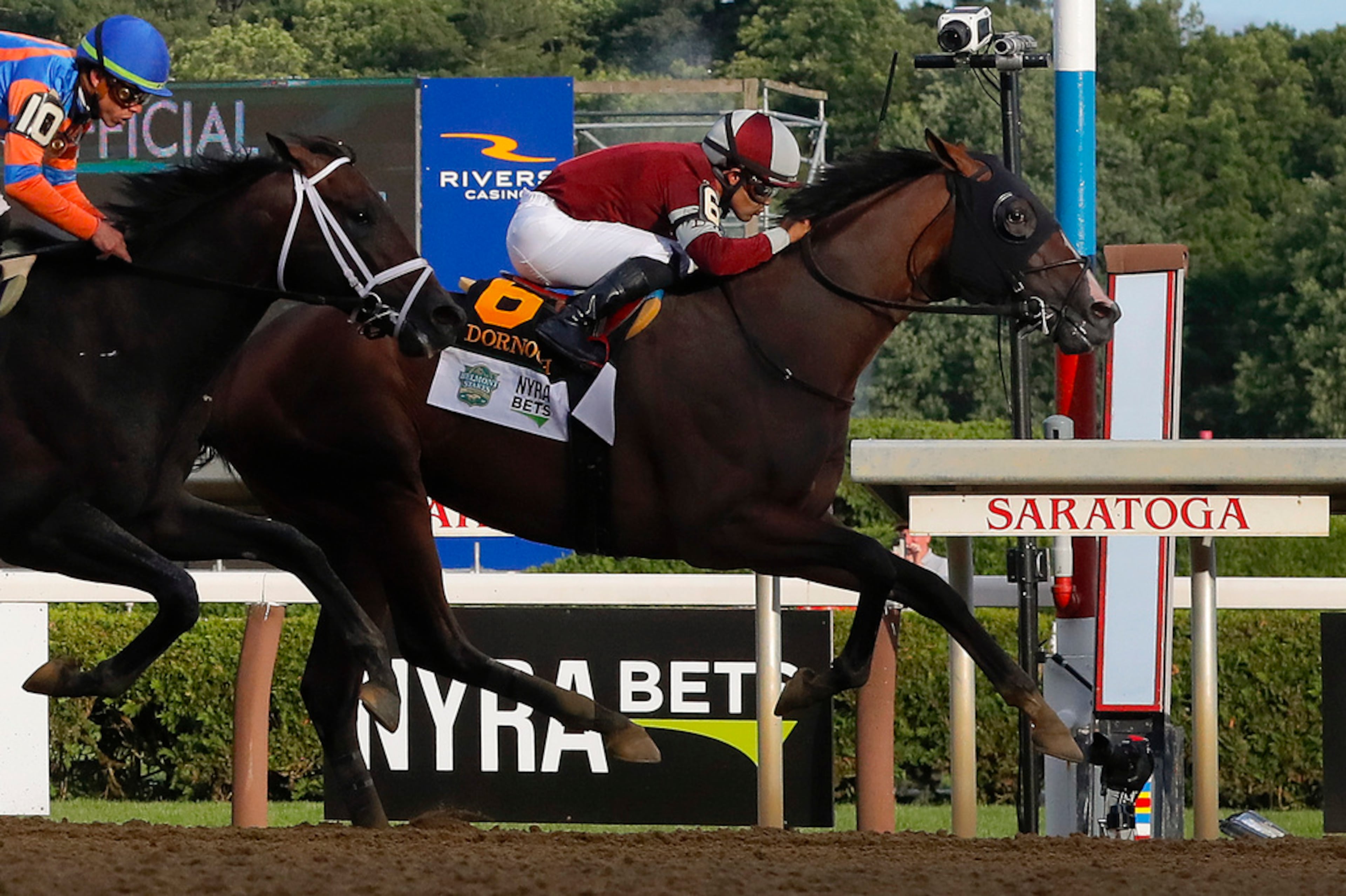 Dornoch, (6), with Luis Saez up, crosses the finish line ahead of Mindframe (10), with Irad Ortiz Jr. up, to win the 156th running of the Belmont Stakes horse race, Saturday, June 8, 2024, in Saratoga Springs, N.Y. (AP Photo/Julie Jacobson)