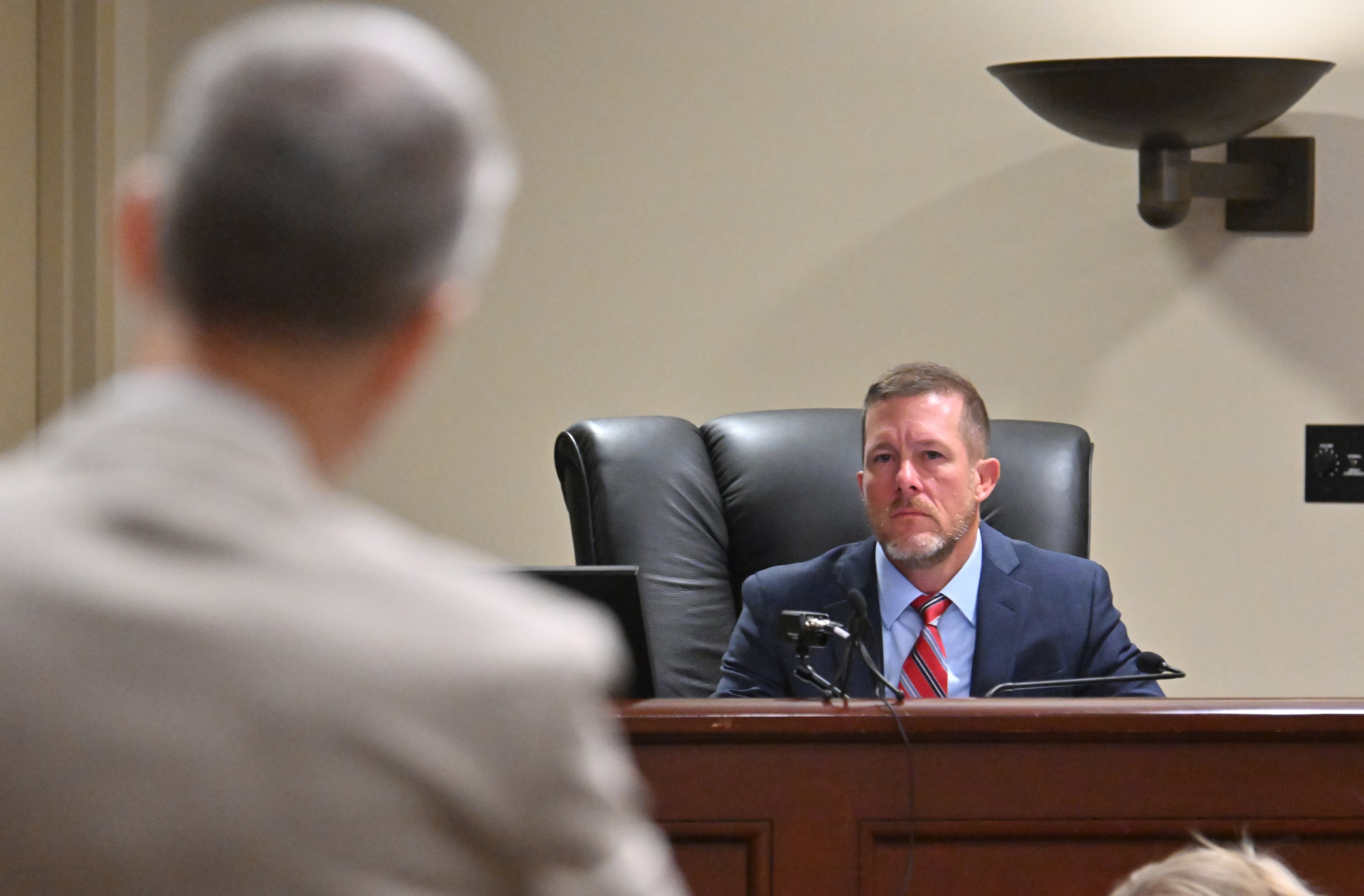 District Attorney Brad Smith (foreground) speaks to Barrow County Superior Court Judge Nicholas Primm during a court hearing for Colin Gray, the father of Apalachee High School shooting suspect Colt Gray, at the Barrow County courthouse, Wednesday, July 23, 2025, in Winder. Two scheduled murder trials in Fulton County forced a Barrow County Superior Court judge to delay the trial against Colin Gray until February. (Hyosub Shin/AJC)
