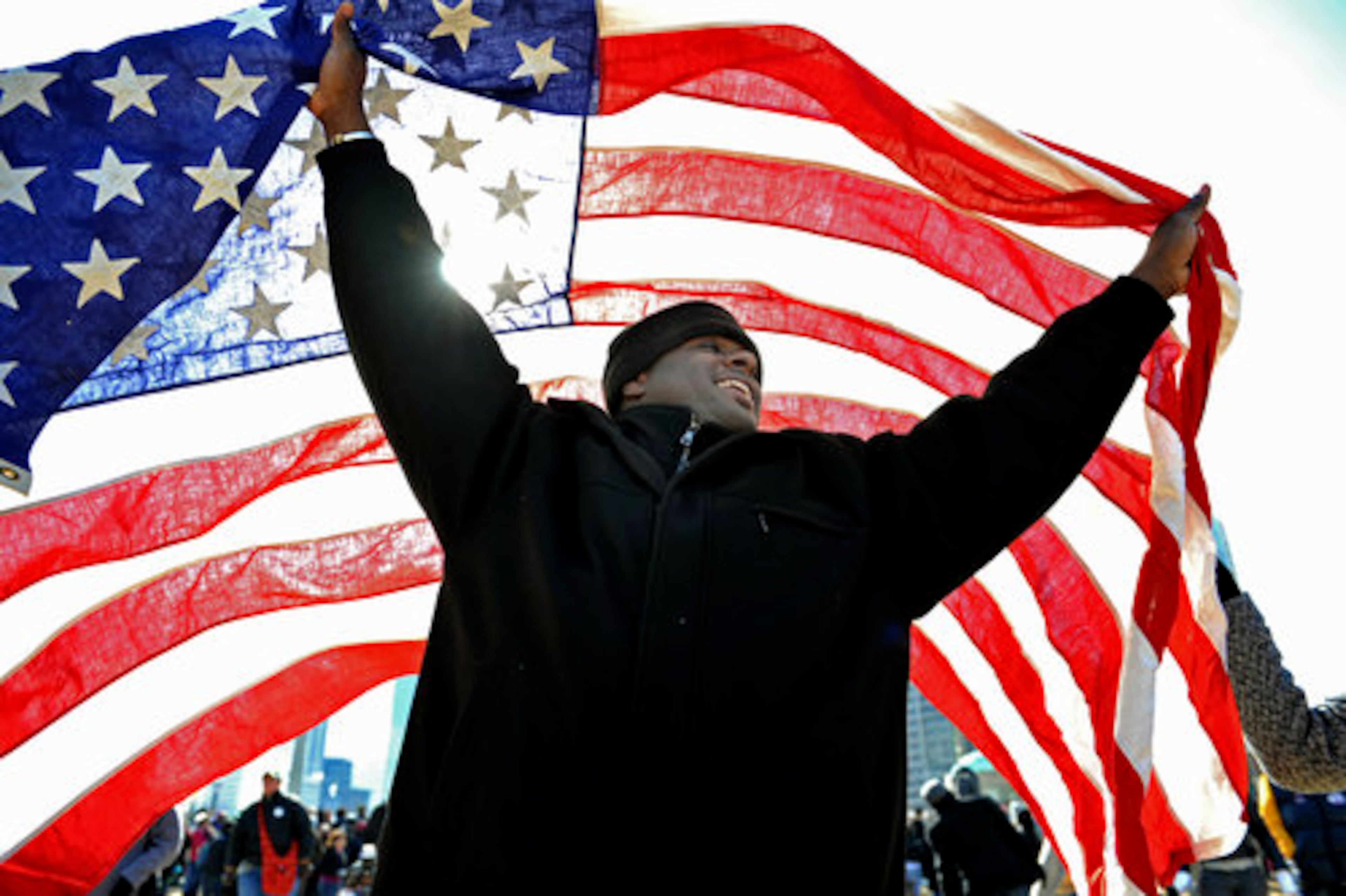 Khaliph West, of Atlanta, brought with him a U.S. flag that belonged to his World War II veteran grandfather to the inaugural gathering at Centennial Olympic Park. After Obama took the Oath of Office, West raised the flag high and cheered the historic moment with all his might.