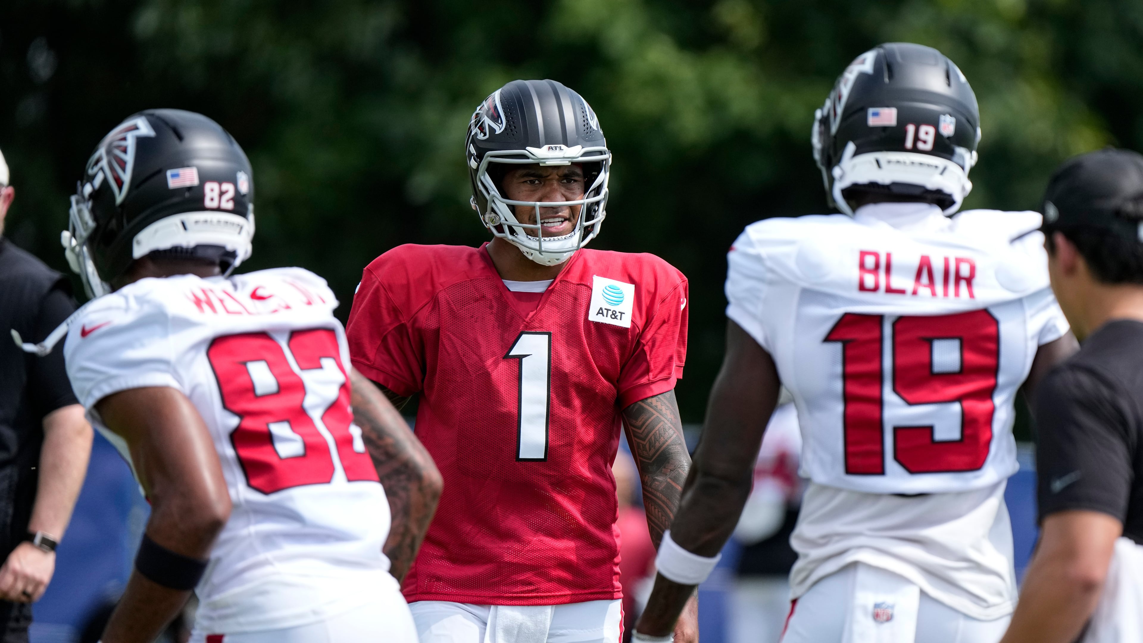 Atlanta Falcons quarterback Tua Tagovailoa (1) cuts between wide receiver Antwane Wells Jr. (82) and wide receiver Chris Blair (19) during a joint practice with the Indianapolis Colts at the team's NFL football training camp in Westfield, Ind., Wednesday, Aug. 19, 2026. (AP Photo/Michael Conroy)
