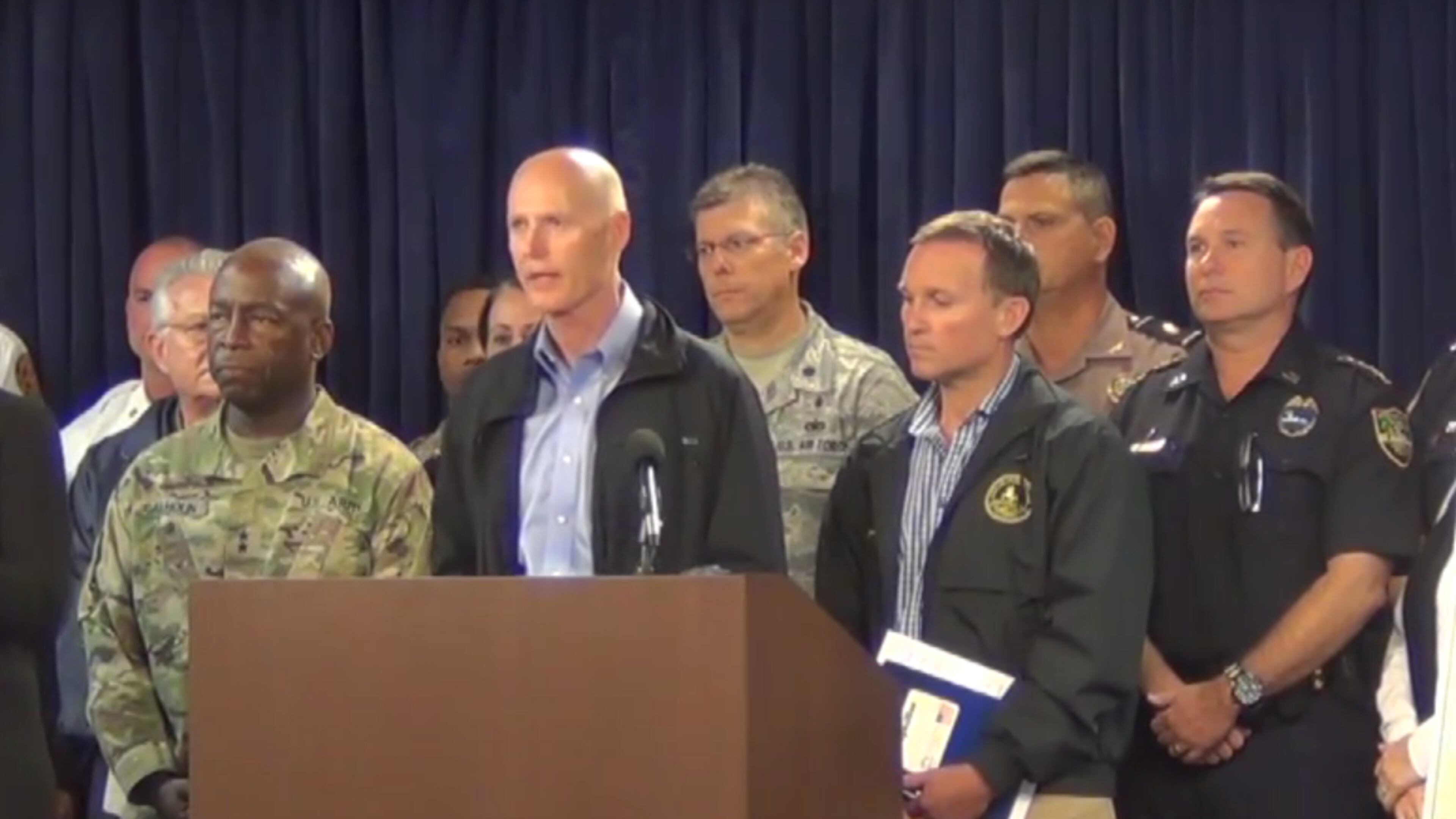 Florida Governor Rick Scott, alongside Jacksonville's mayor and emergency management officials, at a briefing in Jacksonville for Hurricane Matthew