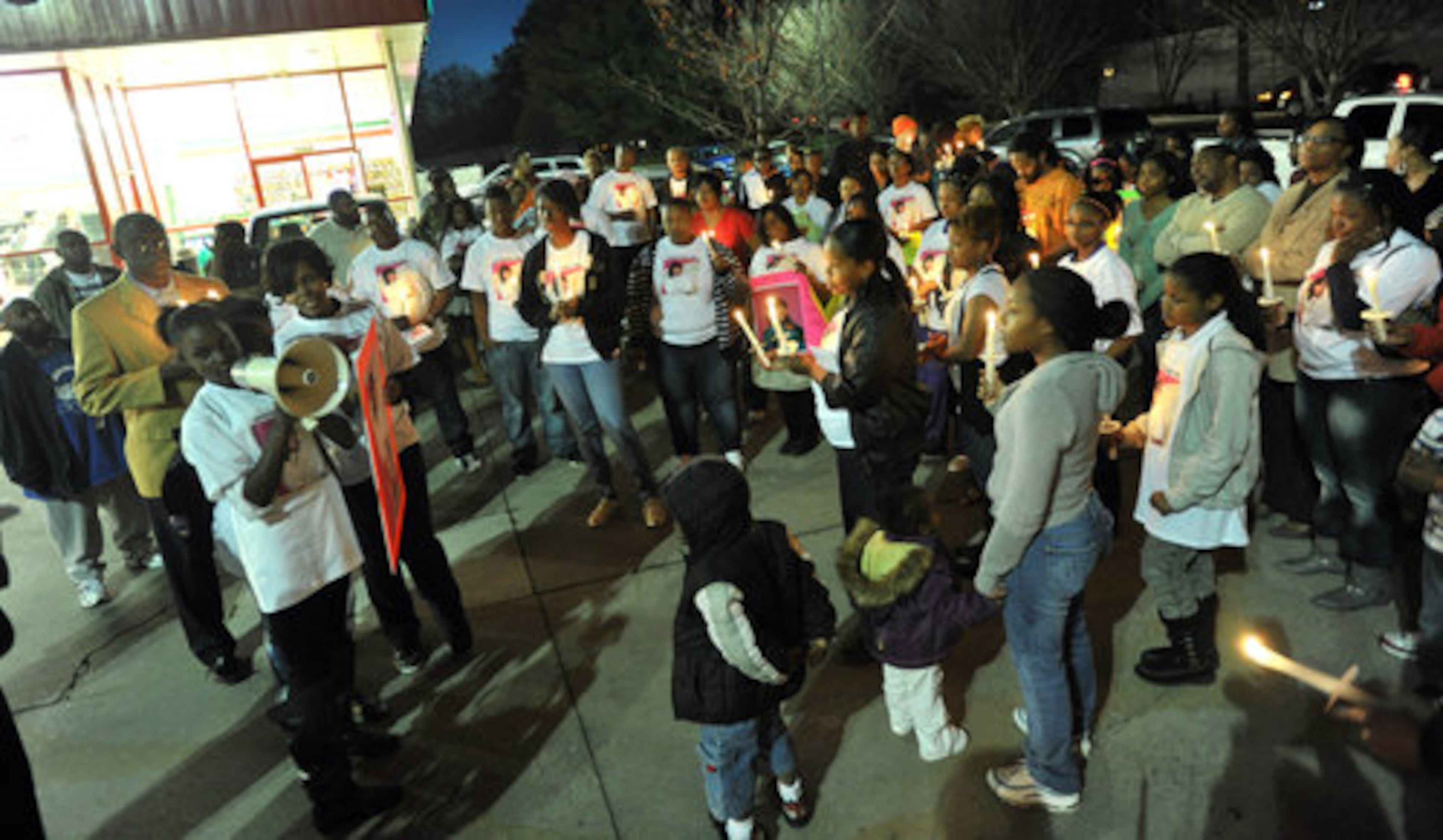 Alexandria Jewell (left), 14, speaks to friends and relatives of her sister Asheley Jewell, the 15-year-old wounded in an apparent road rage shooting, during the candlelight vigil at O'Reilly Auto Parts parking lot on Old National Hwy in College Park near the site of the shooting on Saturday, March 12, 2011.