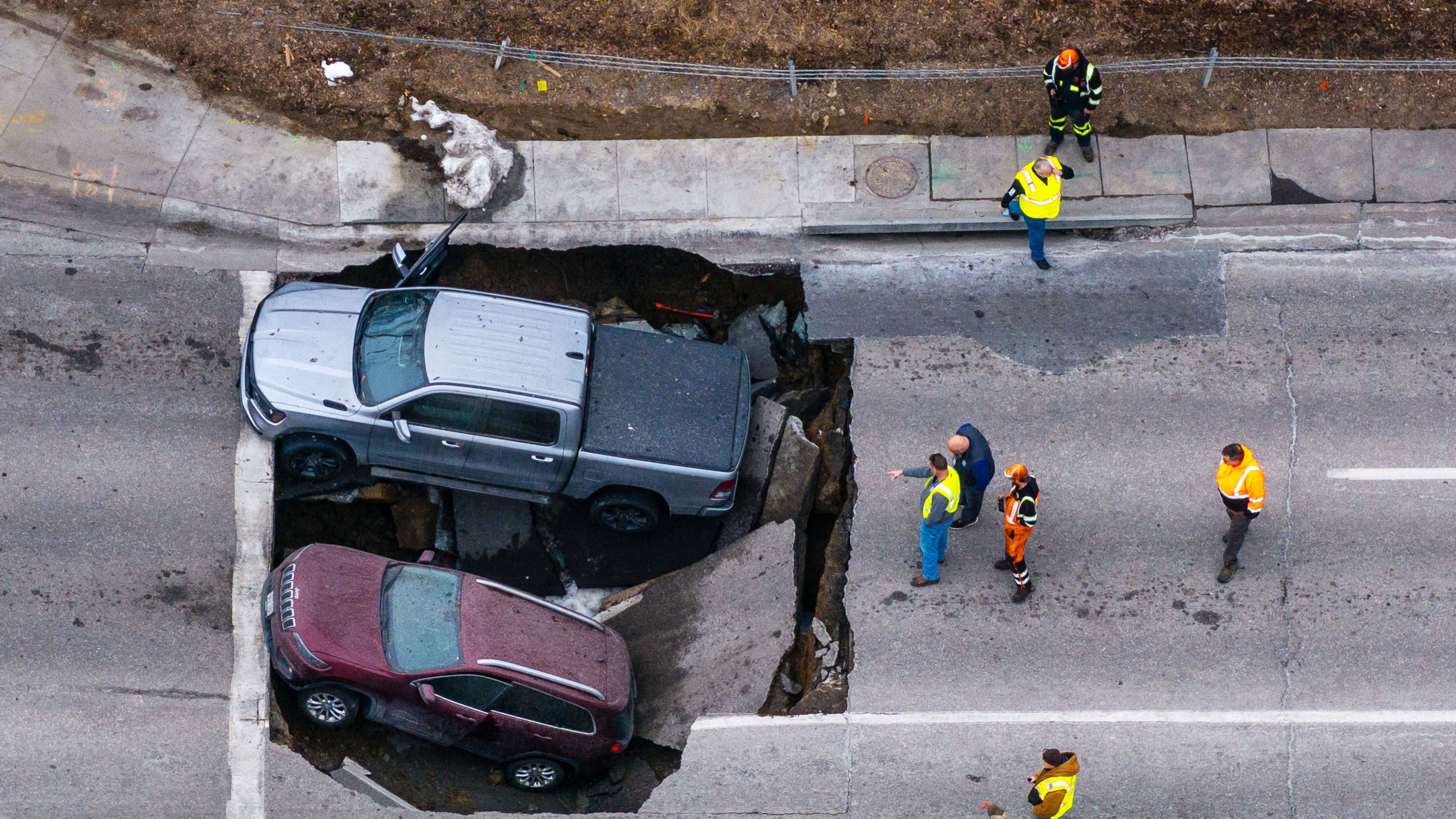 FILE - Authorities assess two vehicles that fell into a sinkhole in Omaha on Feb. 24, 2026. (Chris Machian/Omaha World-Herald via AP, File)