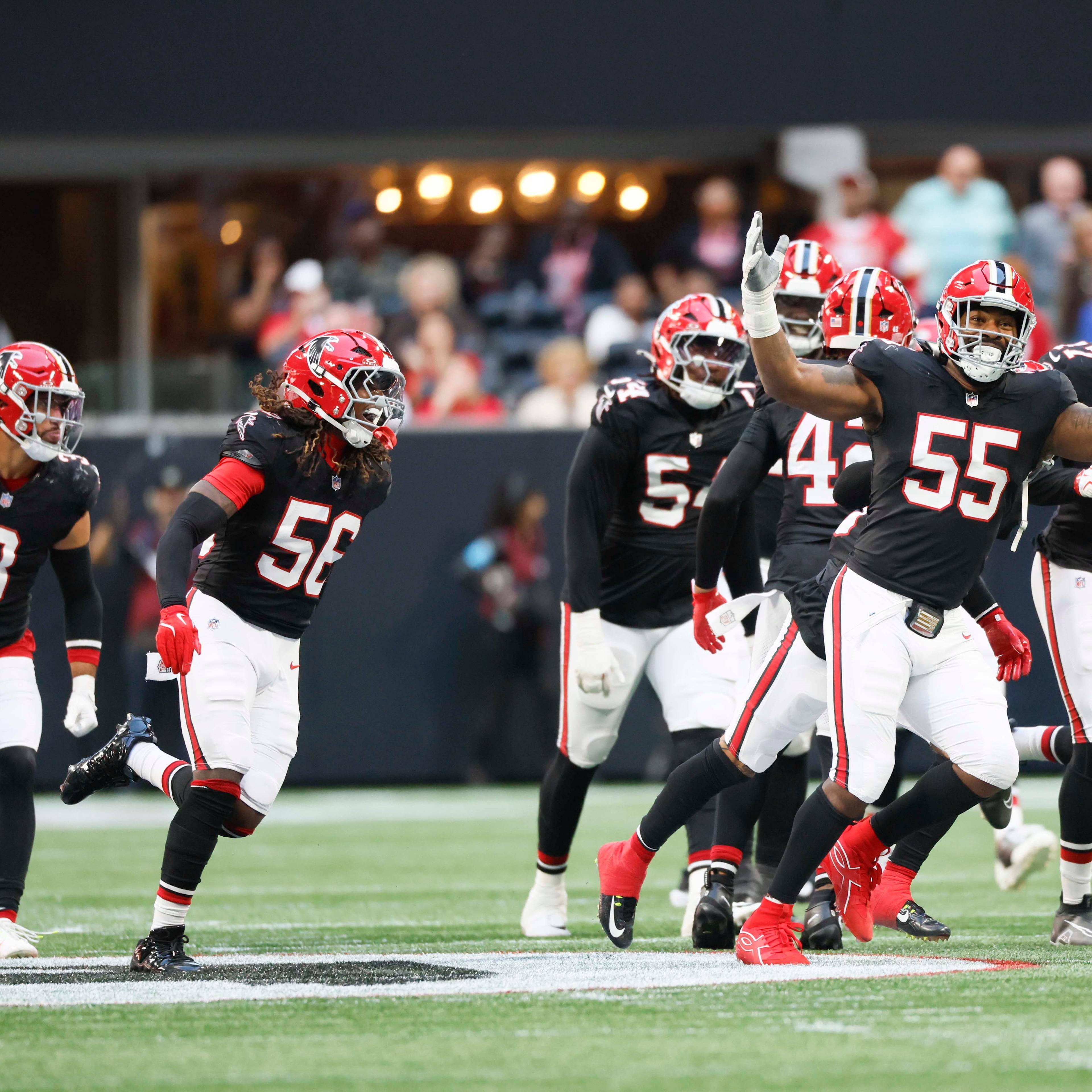 Atlanta Falcons defensive end Za’Darius Smith celebrates with teammates after a sack of the San Francisco 49ers quarterback at Mercedes-Benz Stadium on Sunday. (Miguel Martinez/AJC)