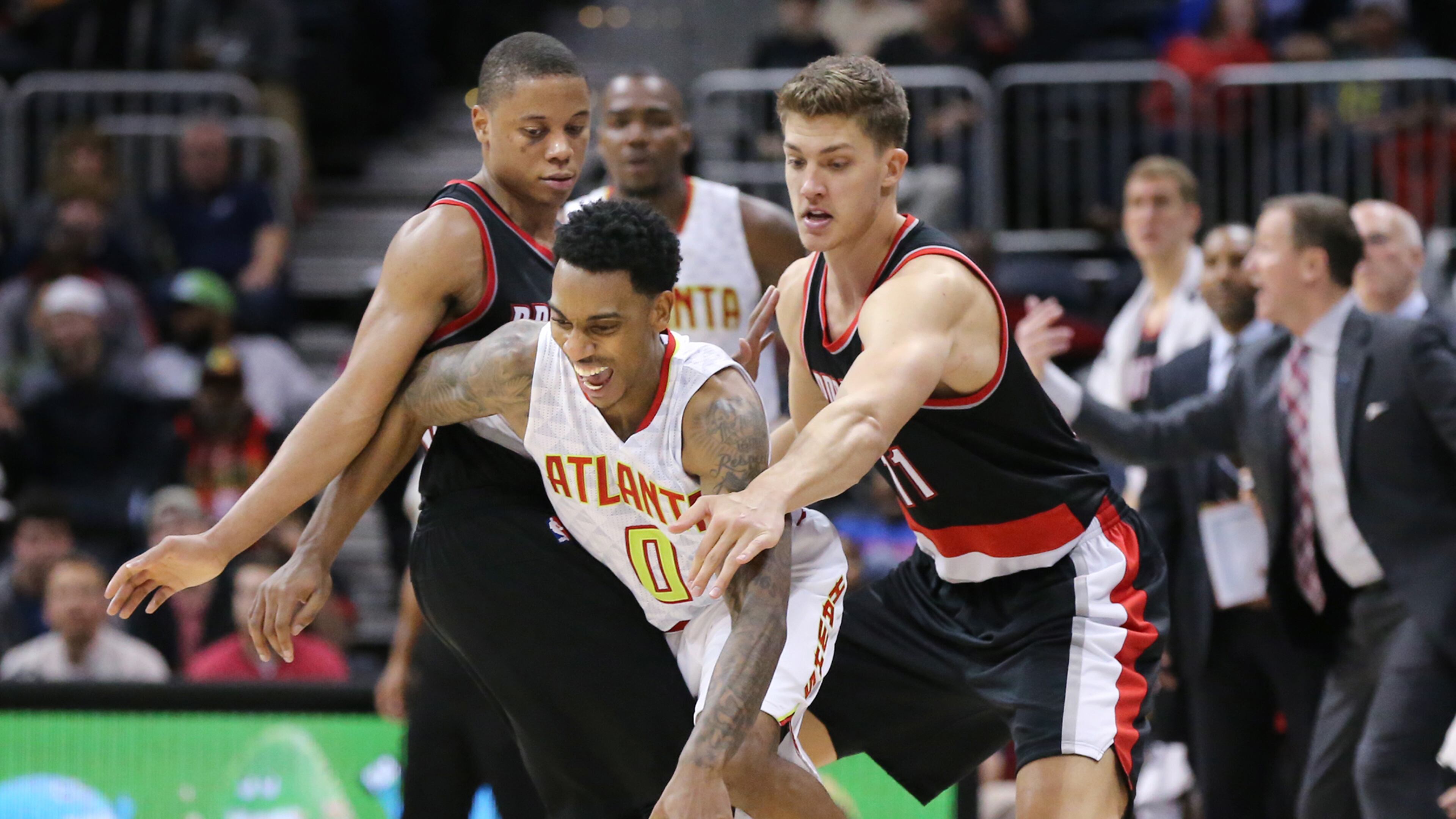 ATLANTA: Hawks guard Jeff Teague is fouled by Trial Blazers defenders Tim Frazier (left) and Meyers Leonard during a basketball game on Monday, Dec. 21, 2015, in Atlanta. The Hawks beat the Trail Blazers 106-97. Curtis Compton / ccompton@ajc.com