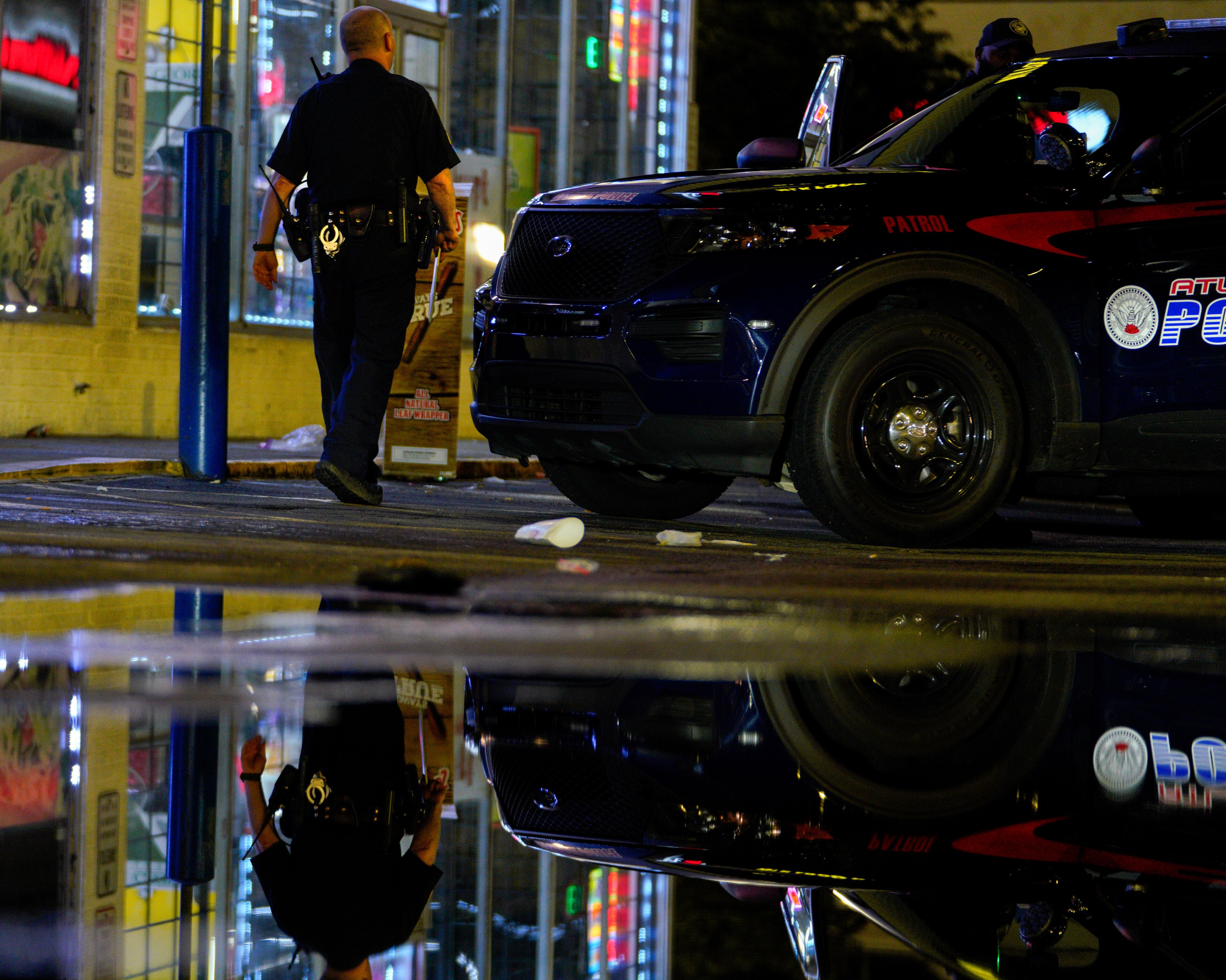 An Atlanta police officer responds to a shooting call in the 2400 block of Martin Luther King Jr. Drive.
