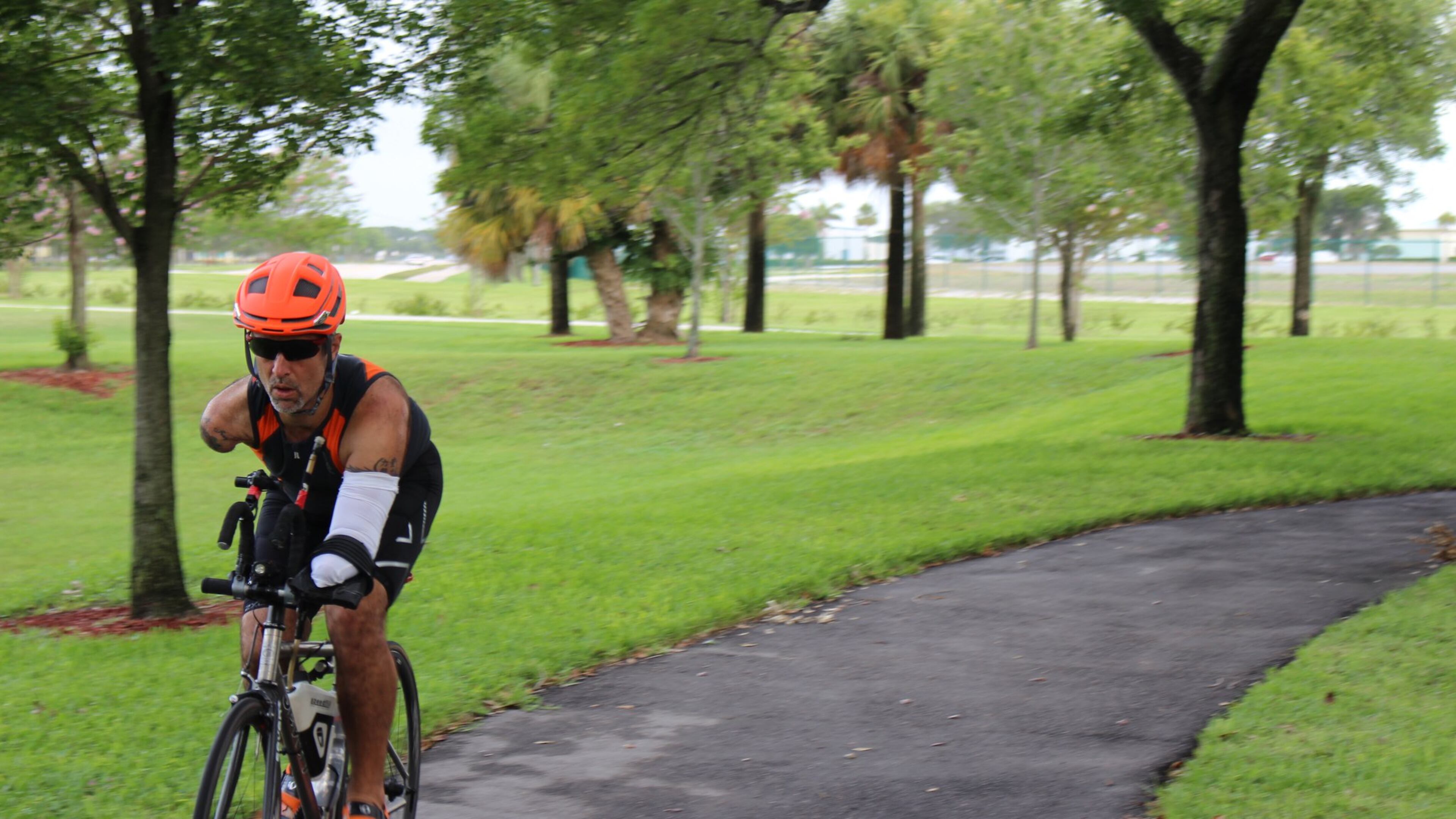 Hector Picard, a double arm amputee who competes in triathlons, has a customized bike where the brakes are moved from the handlebars to the frame, and he uses his right knee to apply the rear and front brakes. He has a specialized sling where his left arm can be attached to the handlebars so he can steer, and he electronically shifts gears using his chin. CONTRIBUTED BY NOVATION SETTLEMENT SOLUTIONS